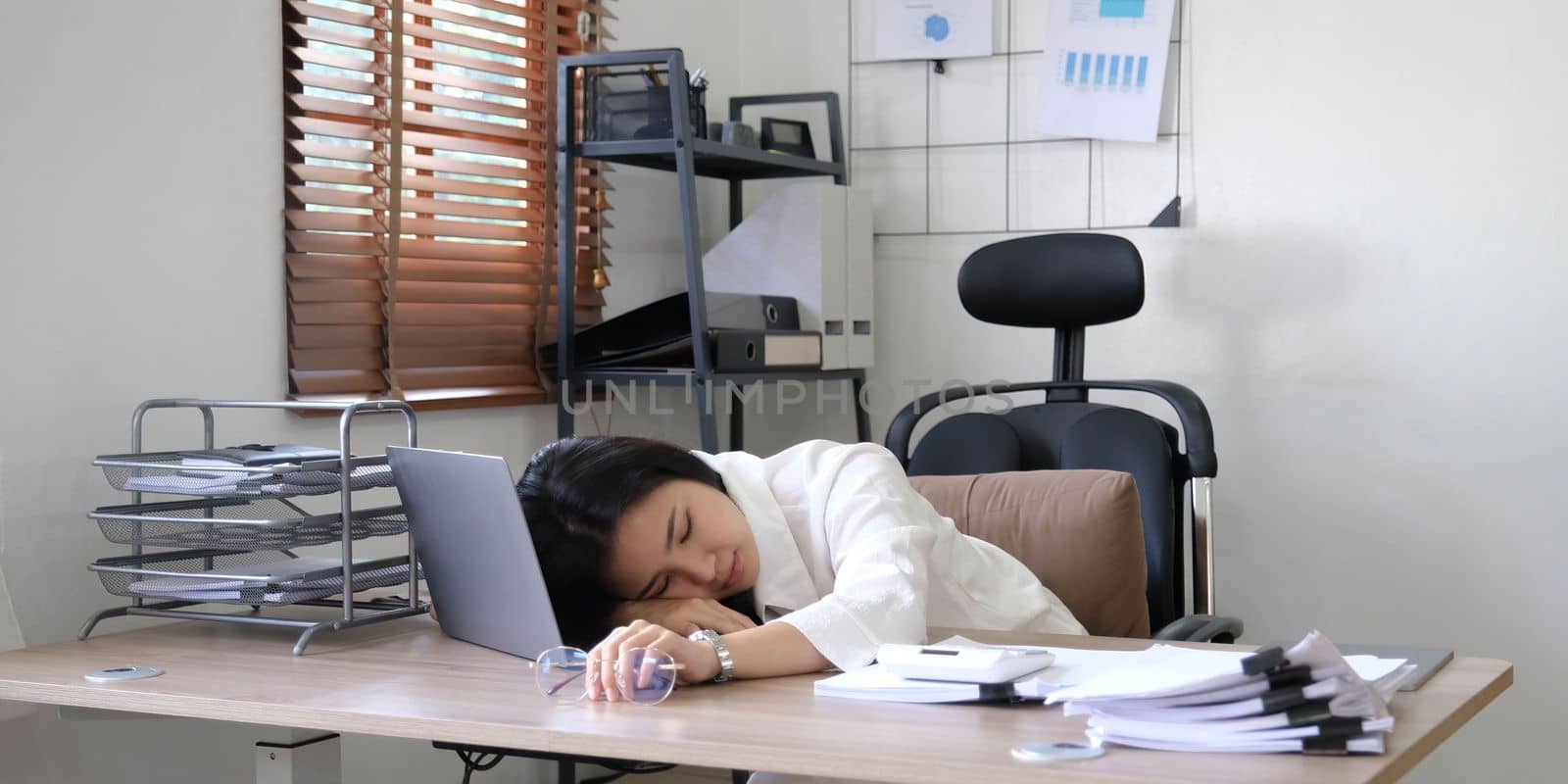 Tired female employee holding head on hand, looking at computer screen, doing hard task, having problem with computer software. Stressed exhausted businesswoman suffering from headache, feeling bored. by wichayada