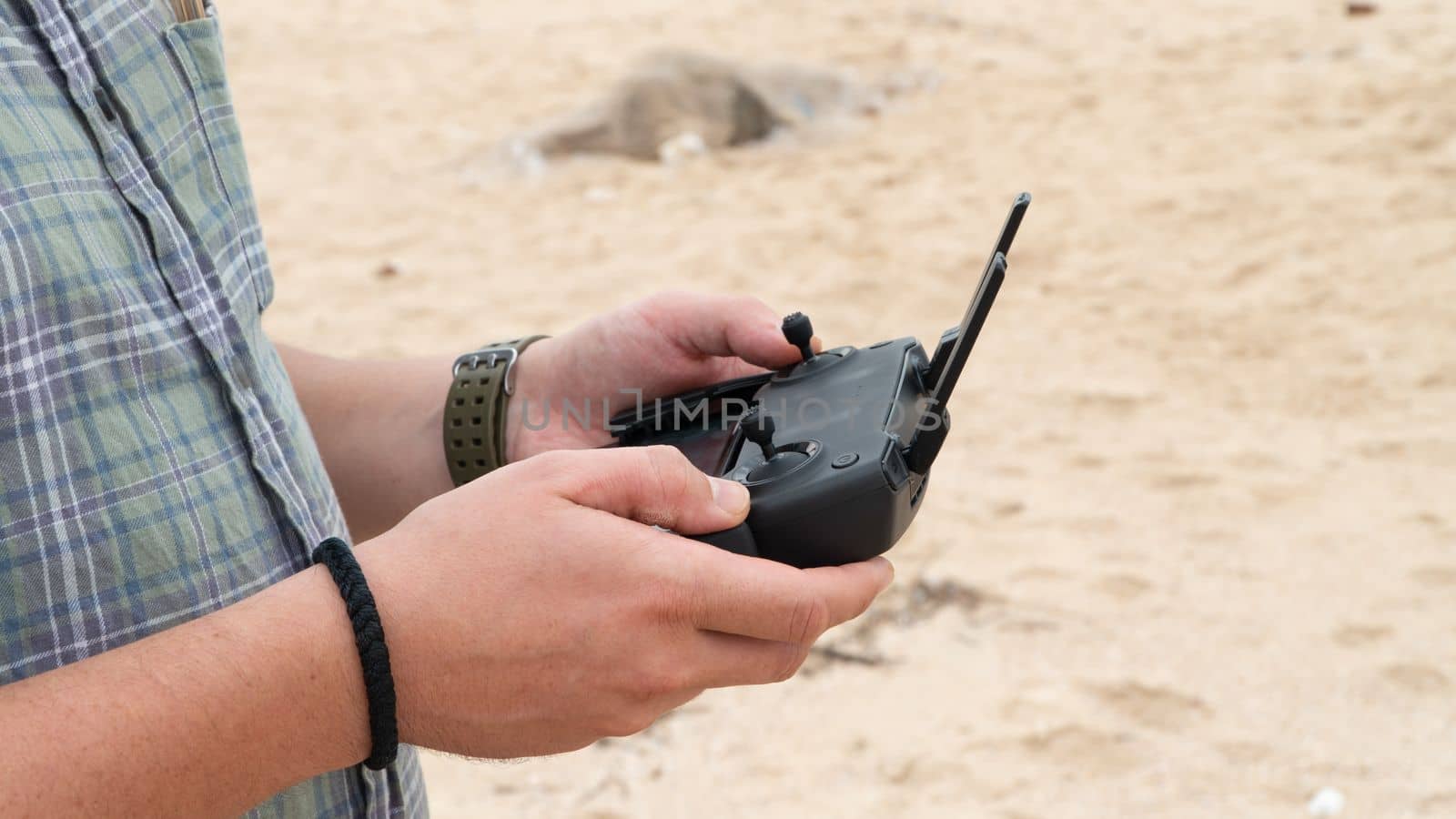 Quadcopter control, joystick in the hands of a photographer and videographer, aerial photography. High quality photo