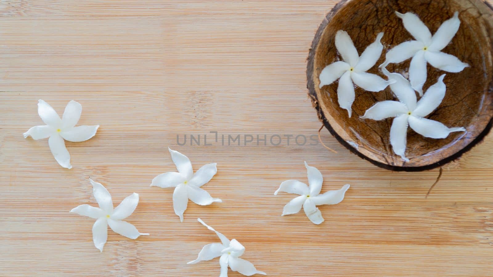 Decor of flowers, white flowers in the water in a bowl of coconut, background. High quality photo