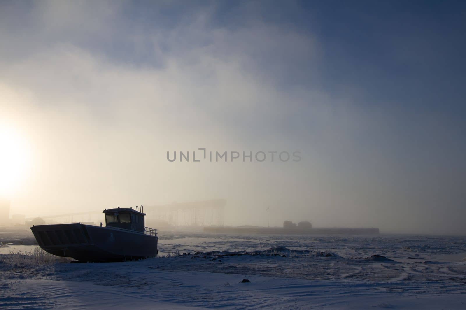 Landing craft centre console aluminum power boat sitting on snow covered beach, near Churchill, Manitoba, Canada