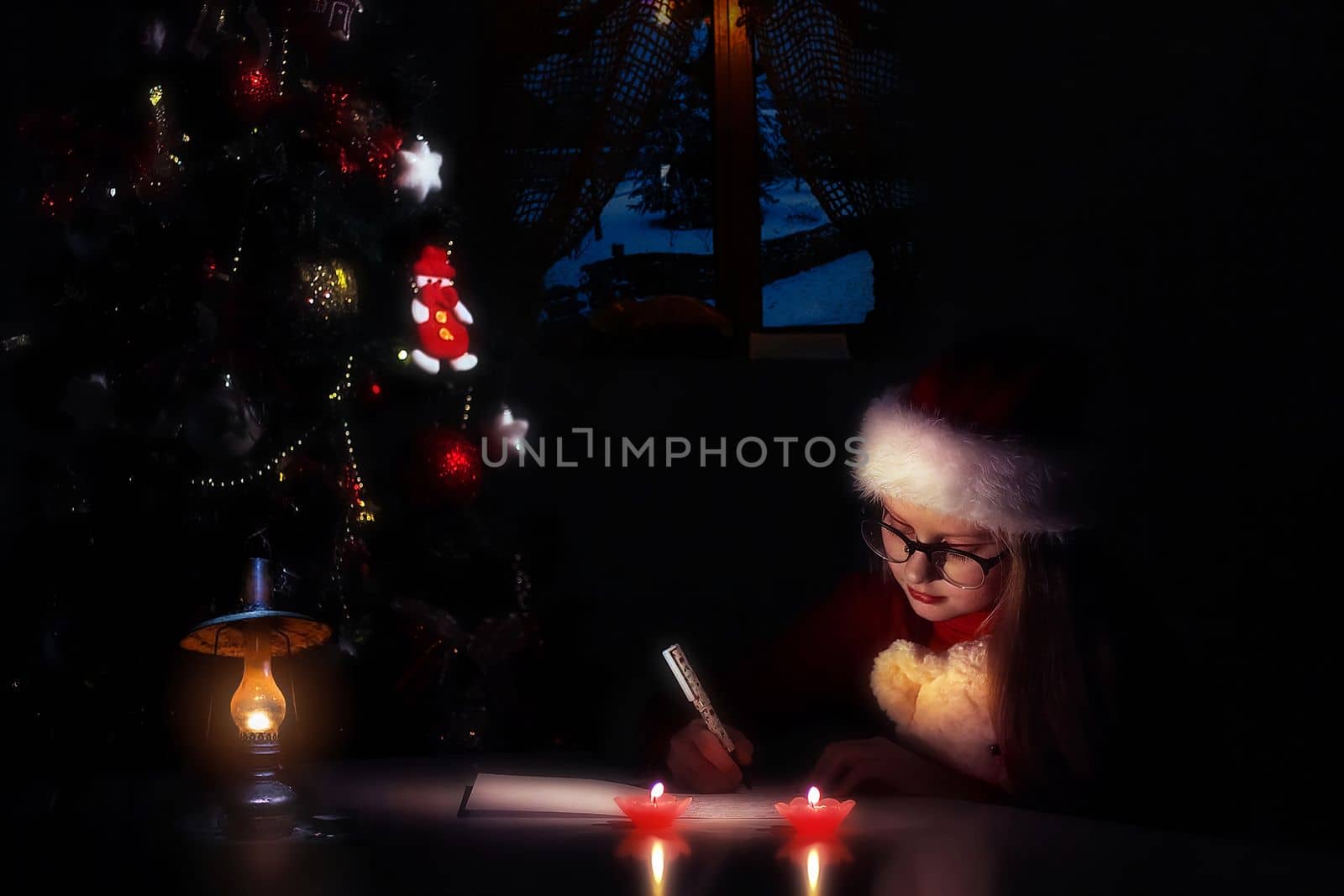 Merry Christmas and Happy Holidays. little child girl in santa claus cap writes letter Santa Claus and dreams of a gift background New Year tree indoors. Greeting card. High quality photo.