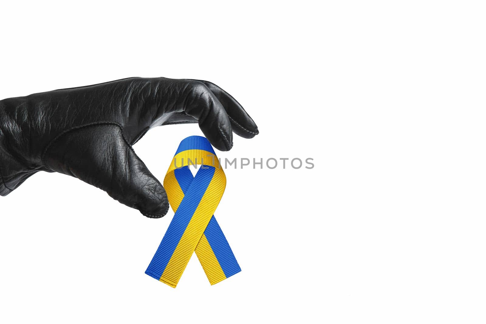 hand of terror in black leather glove reaches out to seize the symbol of freedom of ukraine. concept needs help and support, truth will win