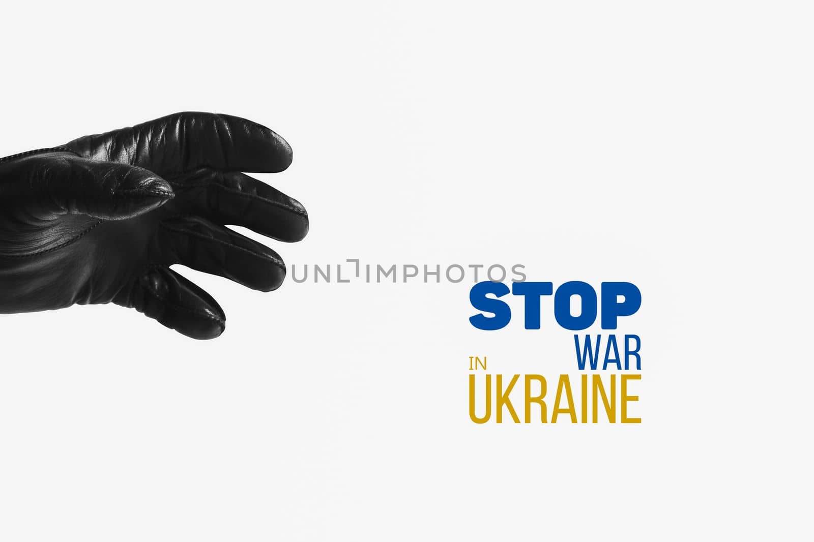 hand of terror in black leather glove reaches out to seize the symbol of freedom of ukraine with words stop war in ukraine. concept needs help and support, truth will win