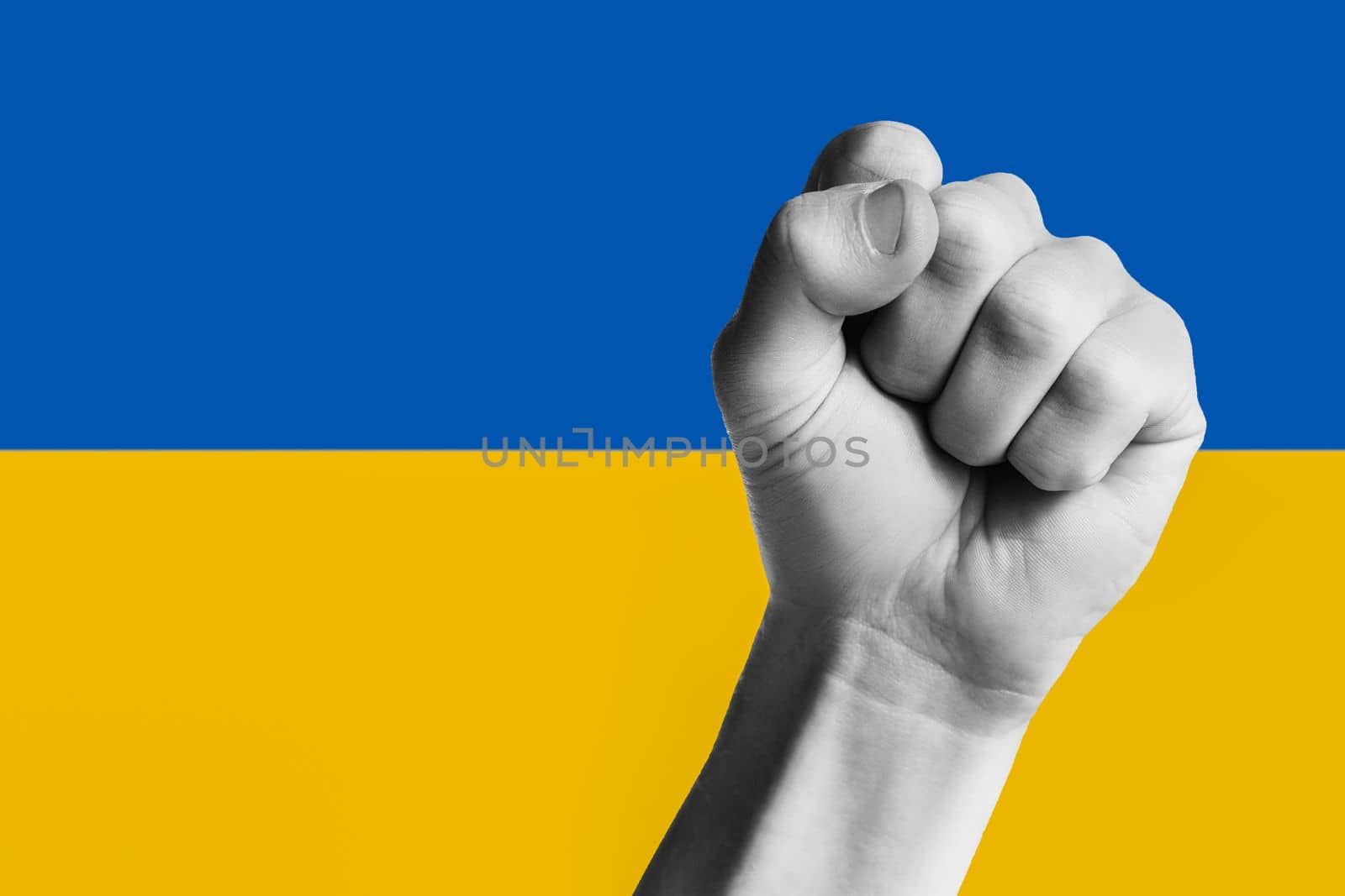 to victory, hand clenched into fist against the background of the yellow blue flag of ukraine. concept needs help and support, truth will win