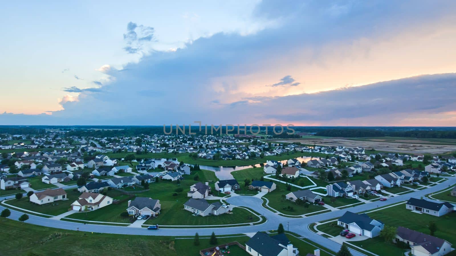 Image of Dusk aerial over suburban Indiana neighborhood housing