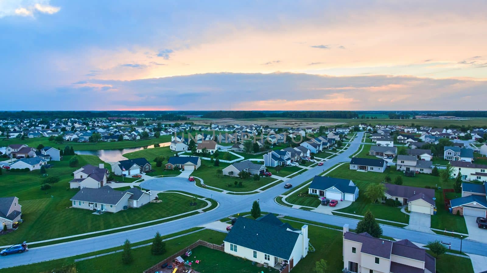 Midwest American suburban neighborhood housing aerial at dusk by njproductions