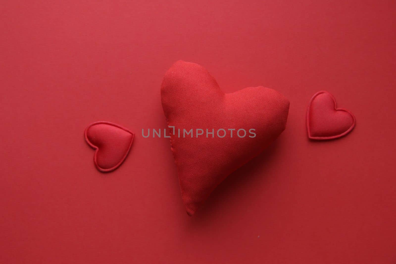 Valentine's Day background. Red heart on a red background.