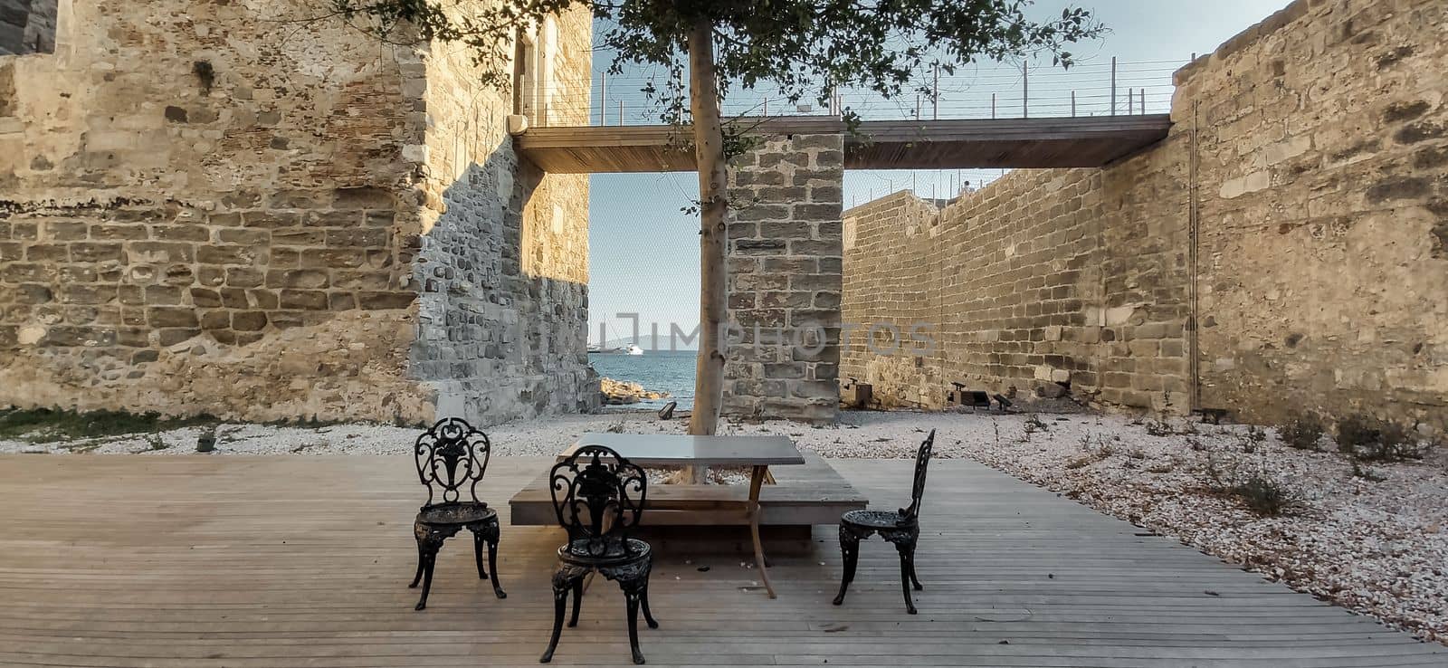 Outdoor seating on the Atlantic coast. The ancient square with outdoor chairs tables of restaurants in the old town of the medieval city. download image