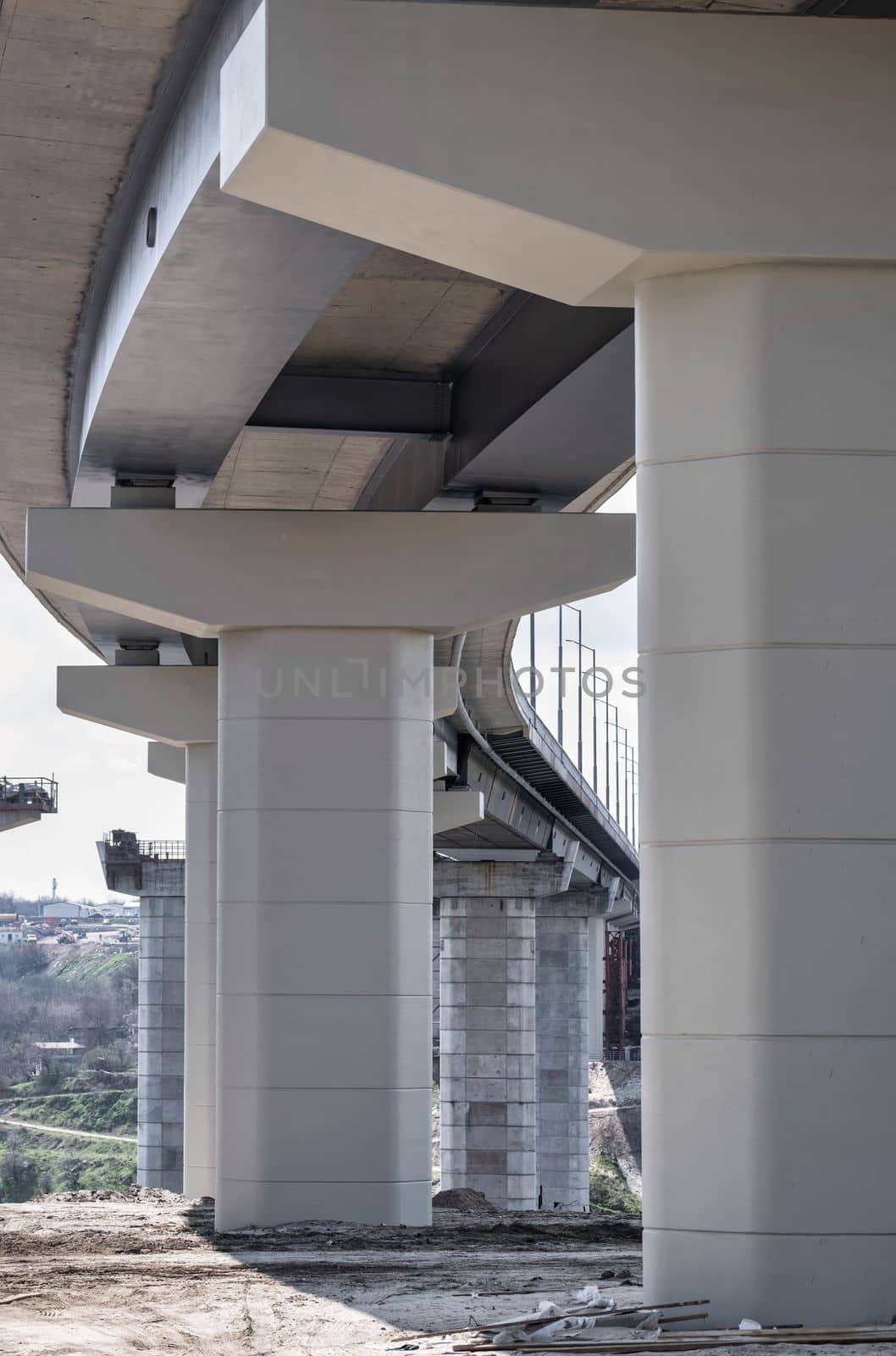 Pillar of bridge. Underside of an elevated roads. Gray pillars support the weight of the structure. Vital part of infrastructure. download image