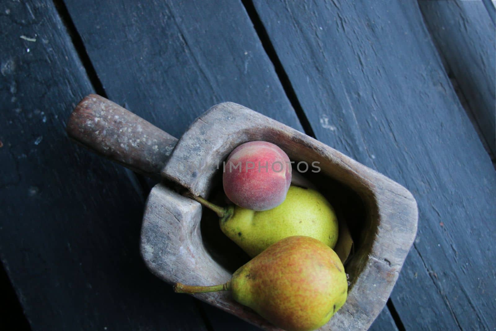 Pears and peach in a wooden box on a vintage table. High quality photo