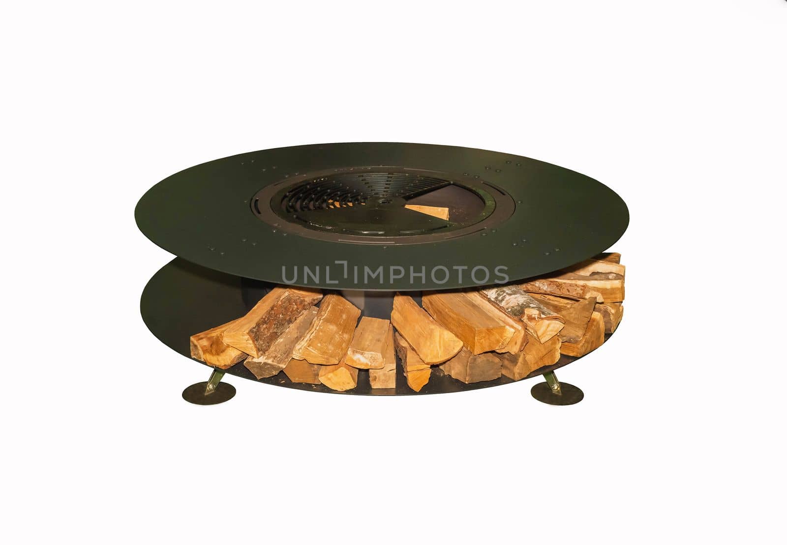 Huge round grill with firewood on white background. Garden equipment for a picnic.