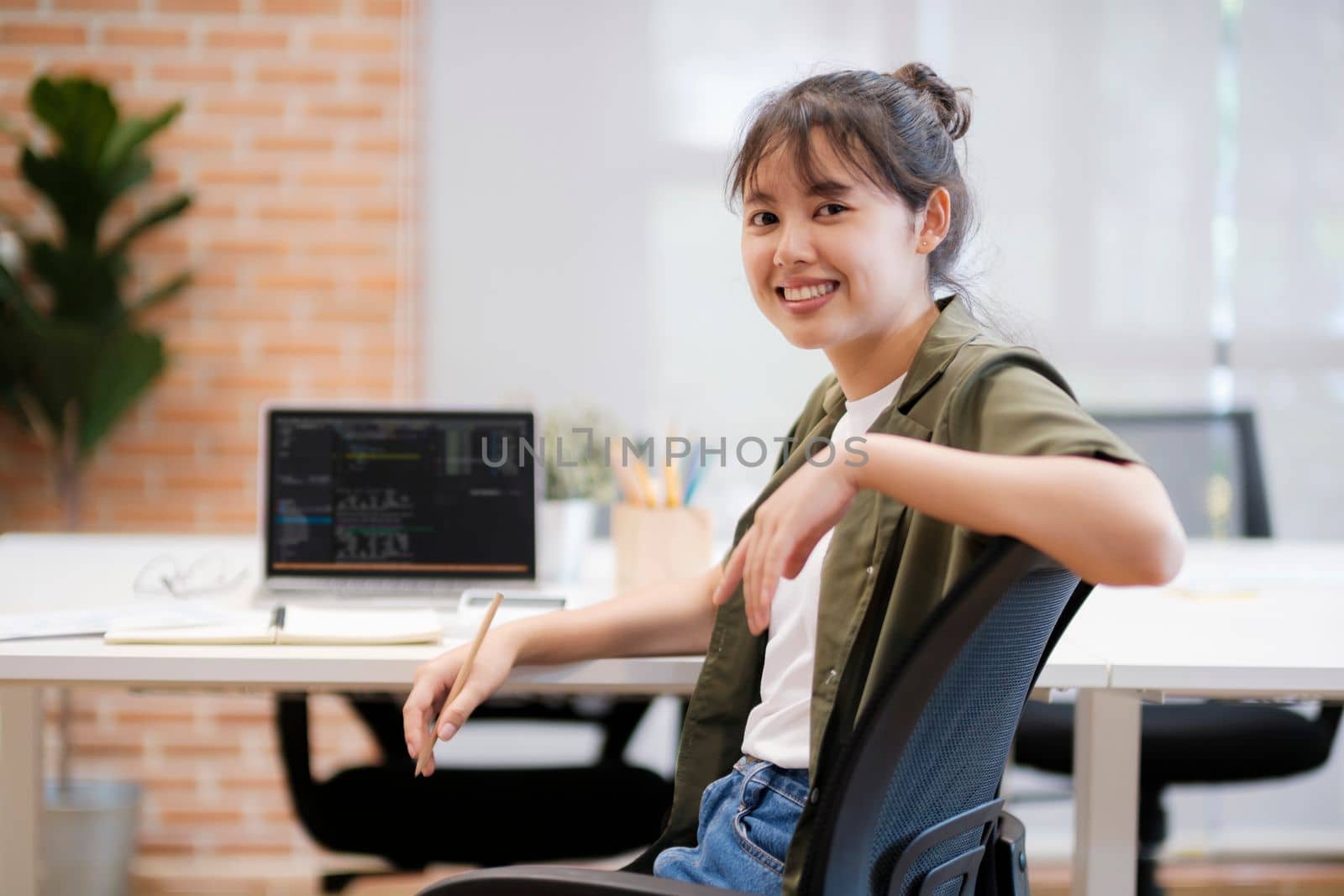 Close up of Businesswoman working at office using laptop Businesswoman smiling at camera. by ijeab