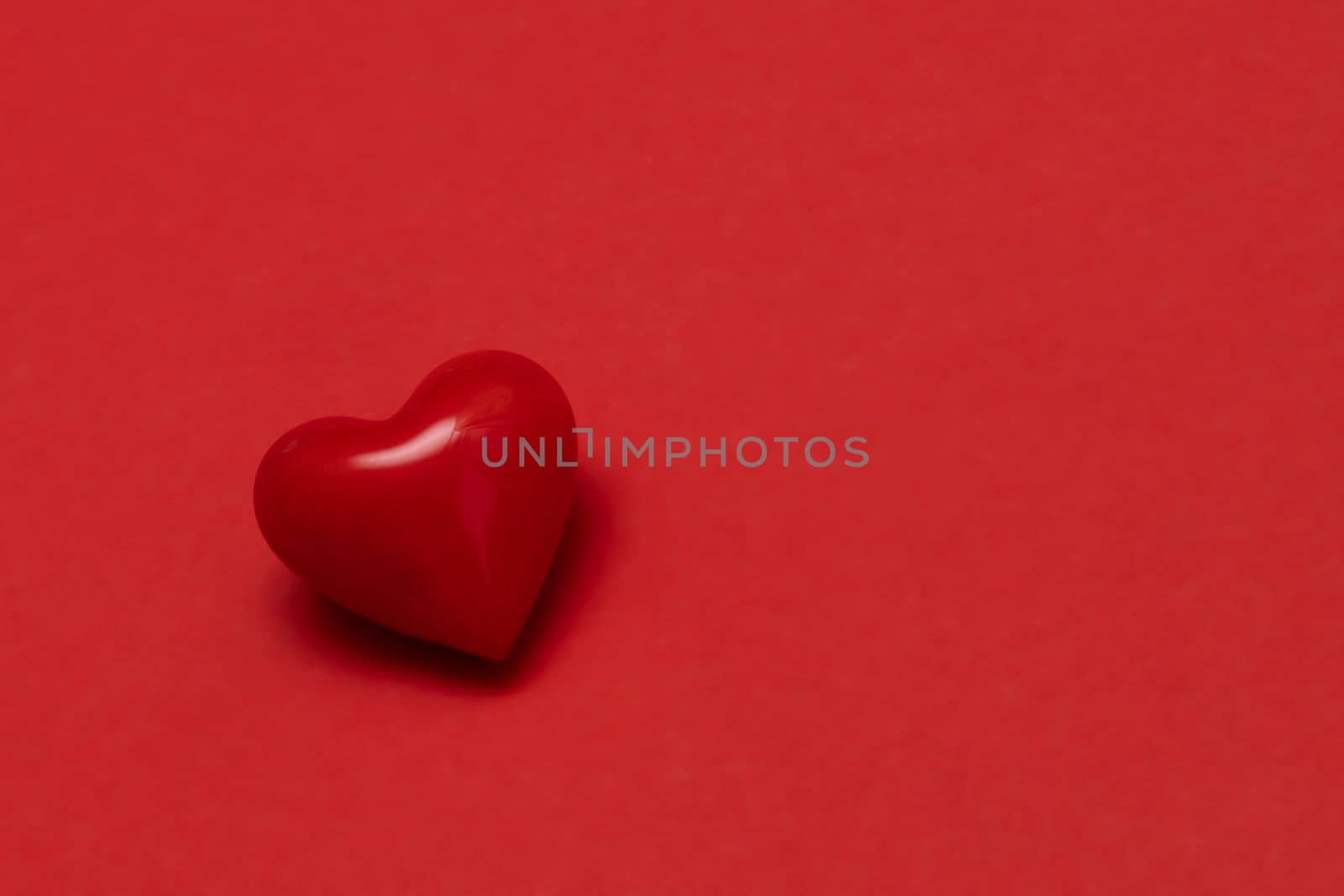 Valentines day red heart on same color background. Monochromatic vivid color. Valentine's day concept. Close up, copy space. by Ri6ka