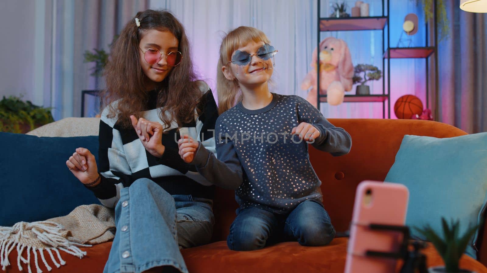 Happy sisters child kids recording on smartphone trendy dance moves for his social media account by efuror