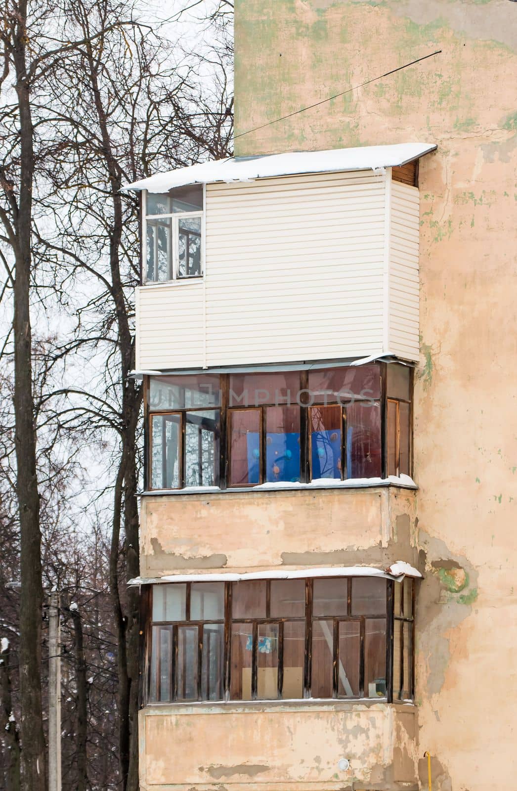 Three glazed balconies one above the other on the corner of an old house. by anarni33