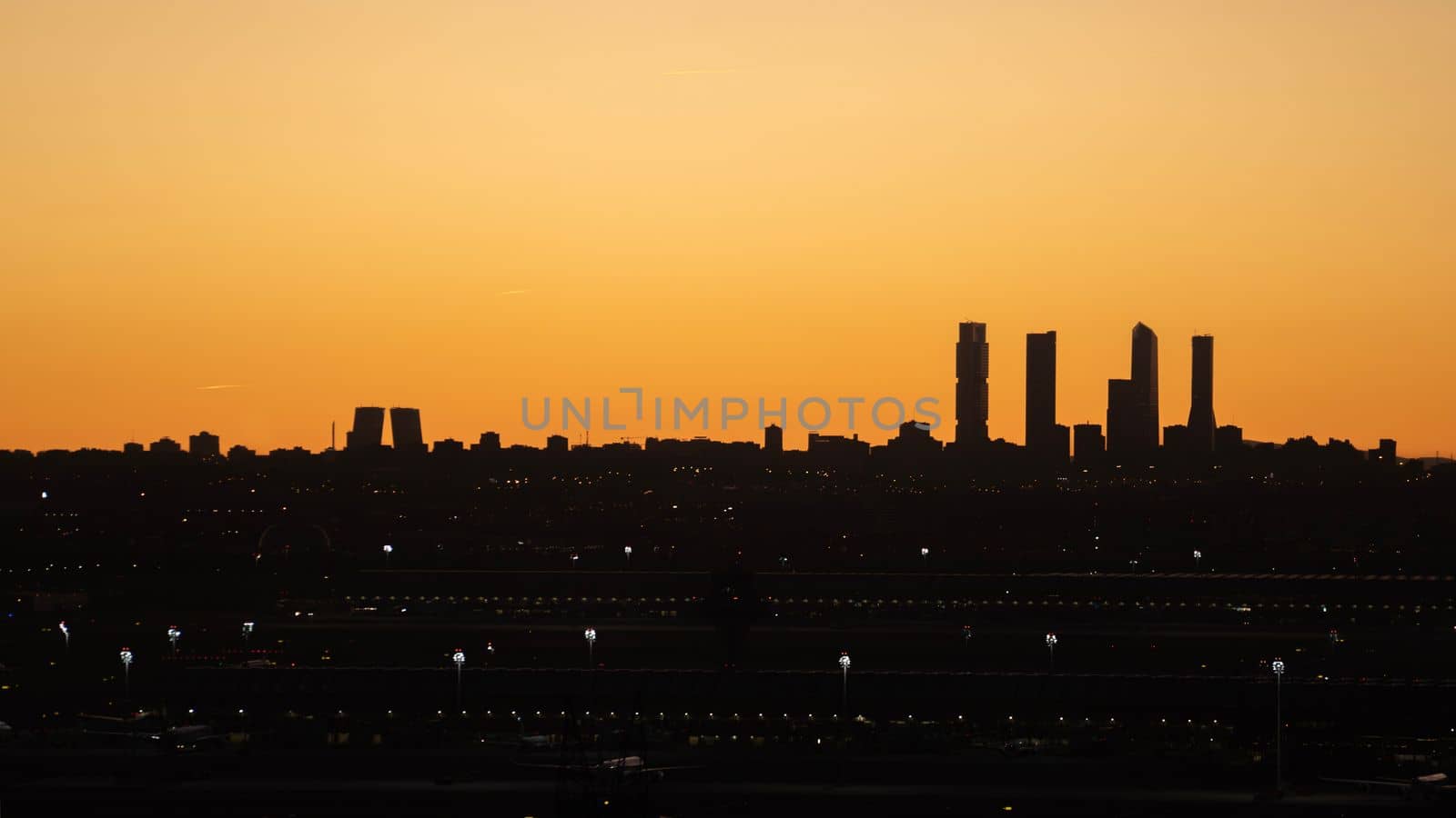 Silhouette of Madrid skyline with its towers after sunset. Gold coloured sky. Summer concept with copy space.