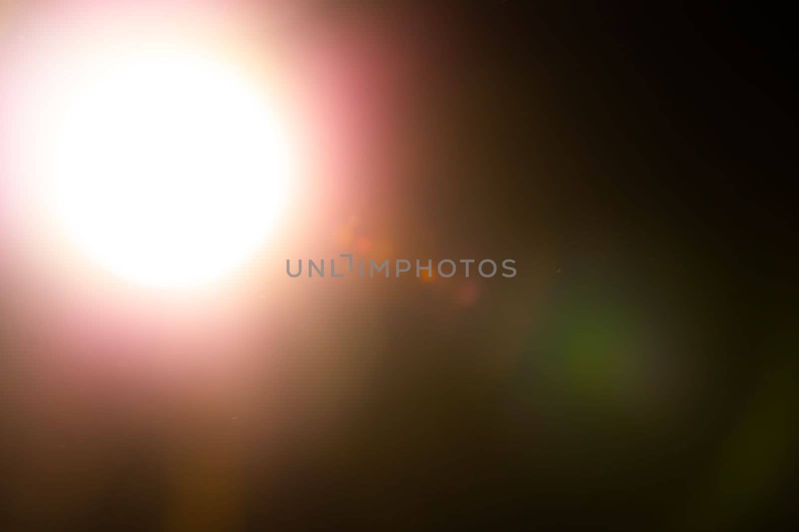 Warm lens flares overlay on black background. Spherical Optical Light leak. High quality photo