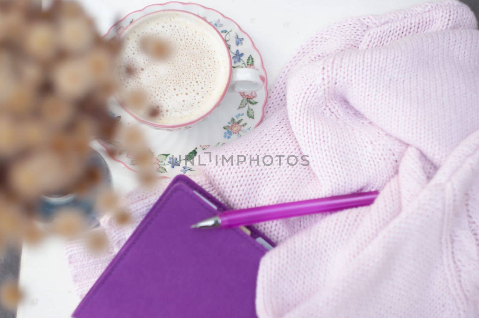 a cup of cappuccino with pink copybook and pen, view from above, pastels color, spring pink lifestyle, morning mood, High quality photo
