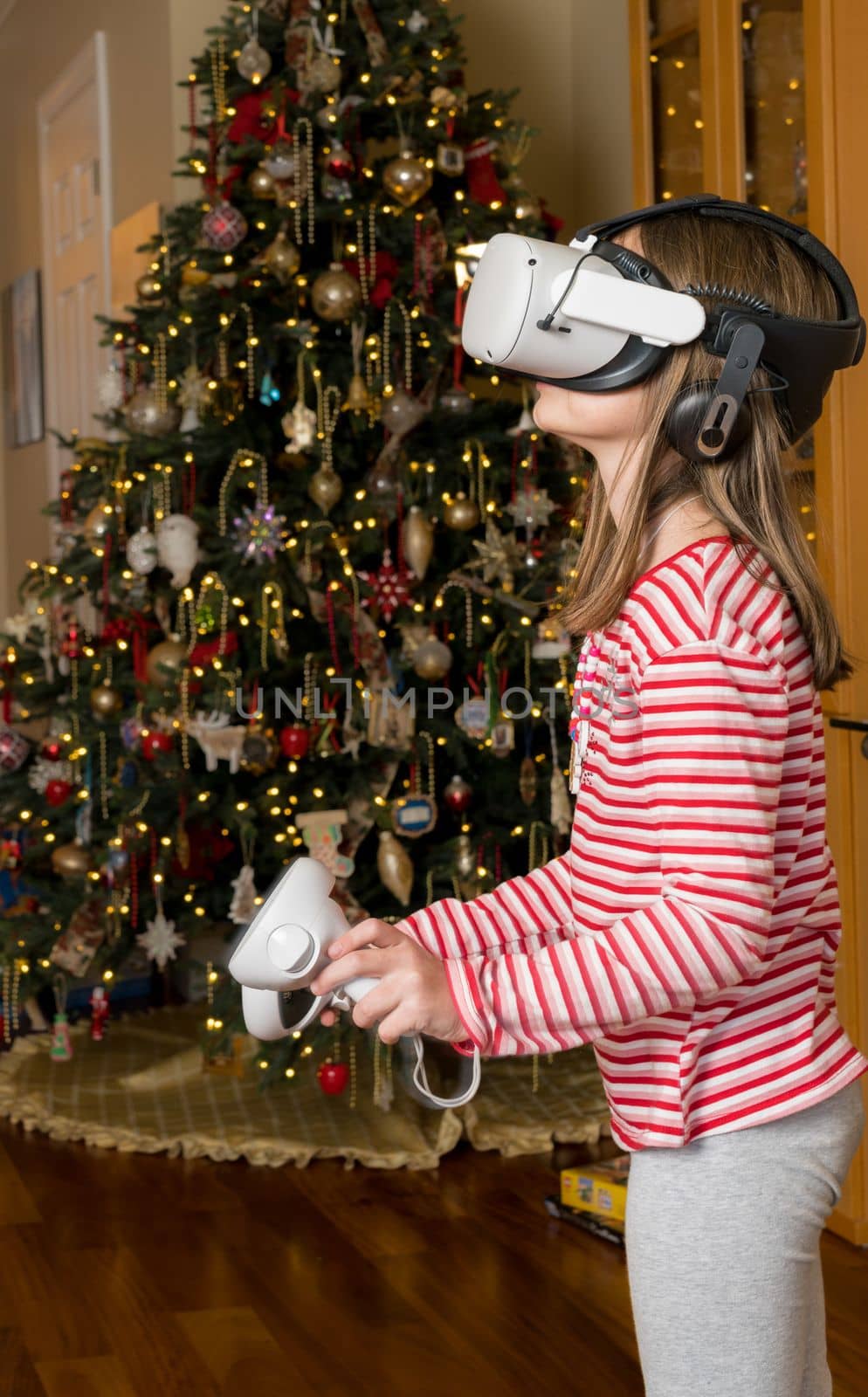 Young girl playing a game at Christmas on a modern virtual reality VR headset