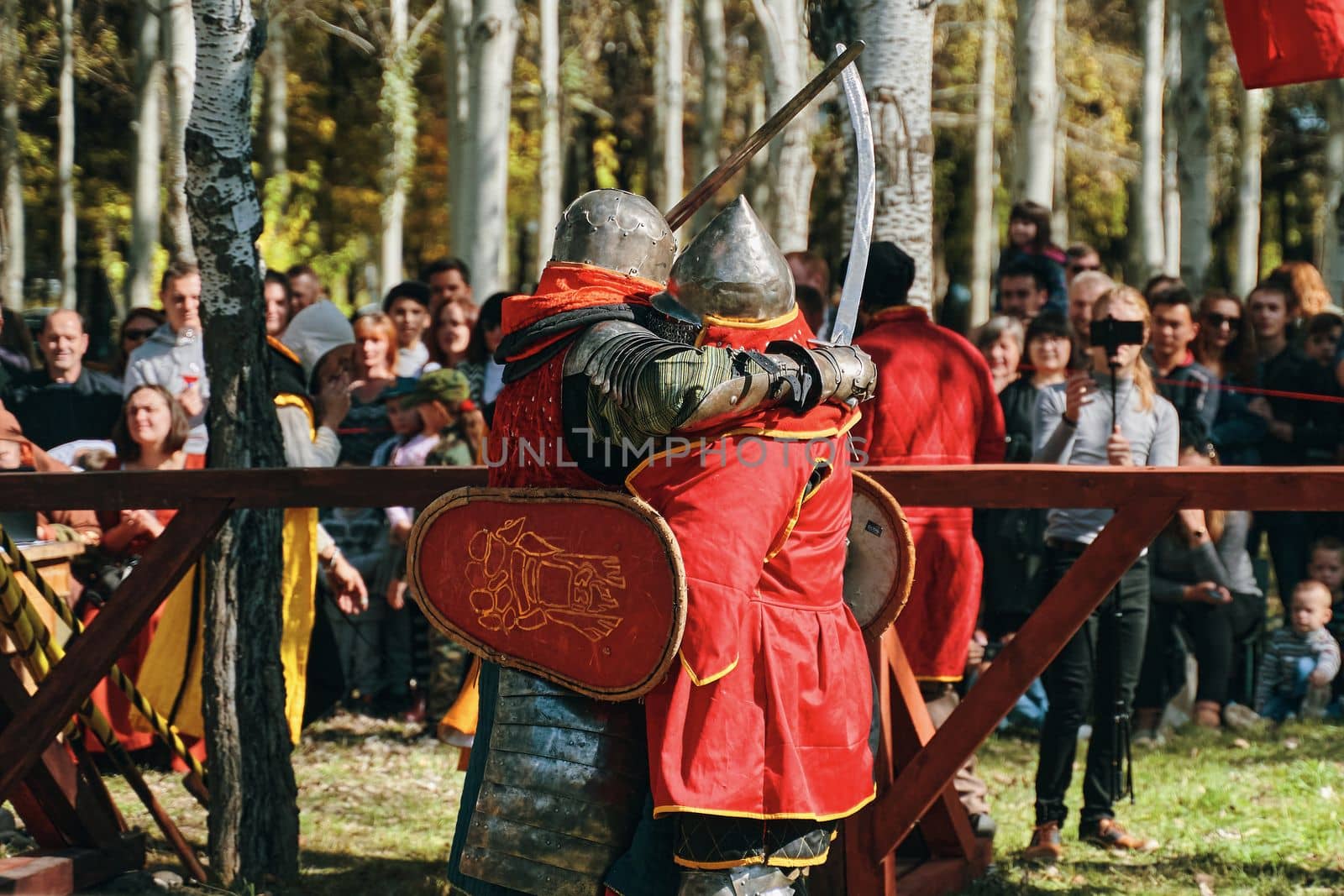 Two knights embrace each other as a sign of respect. Festival of jousting tournaments. Simulation of medieval battles during the festival of historical clubs. Bishkek, Kyrgyzstan-October 13, 2019.
