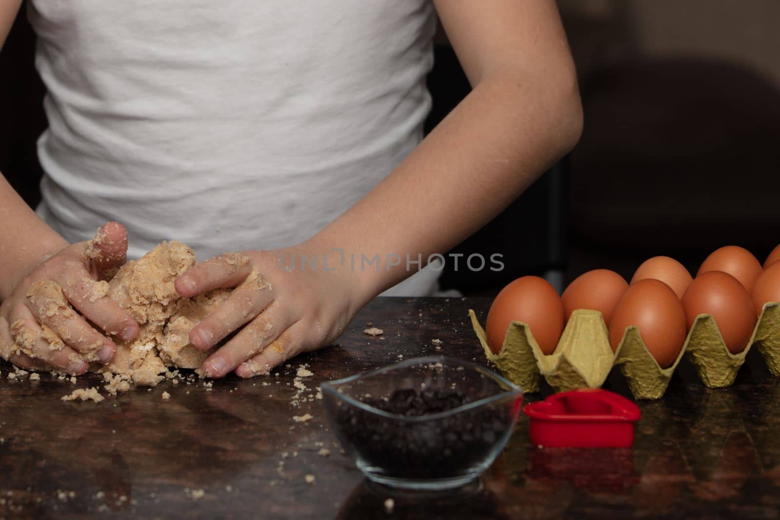Close-up child`s hands preparing cookies by senkaya