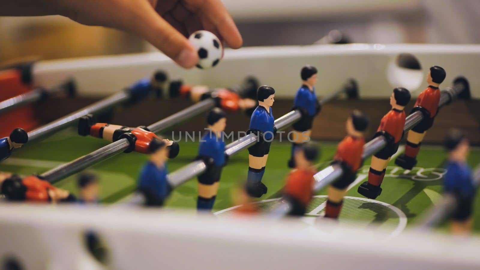 Players play table football in the clubhouse