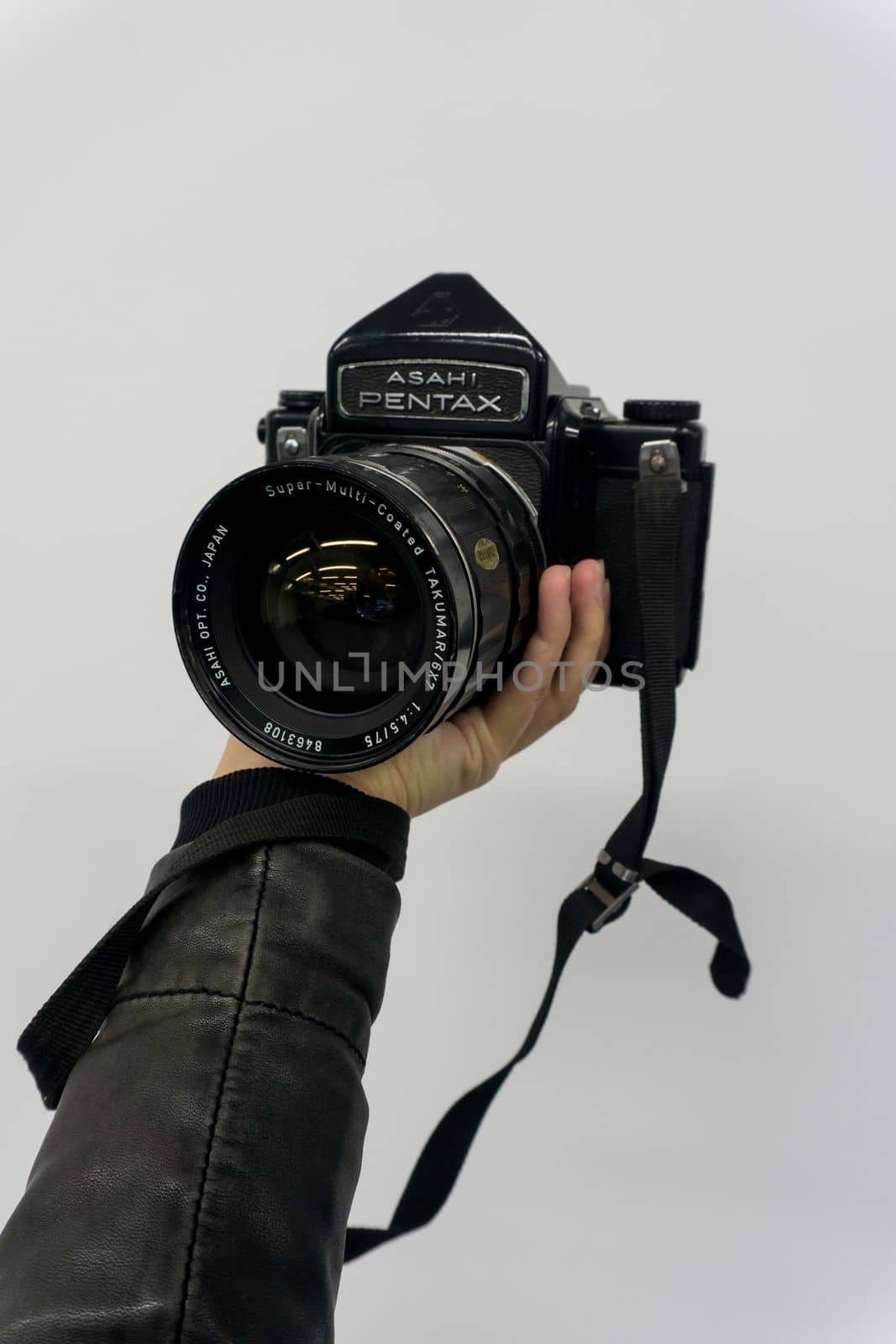 Huge retro Pentax camera in hand close up