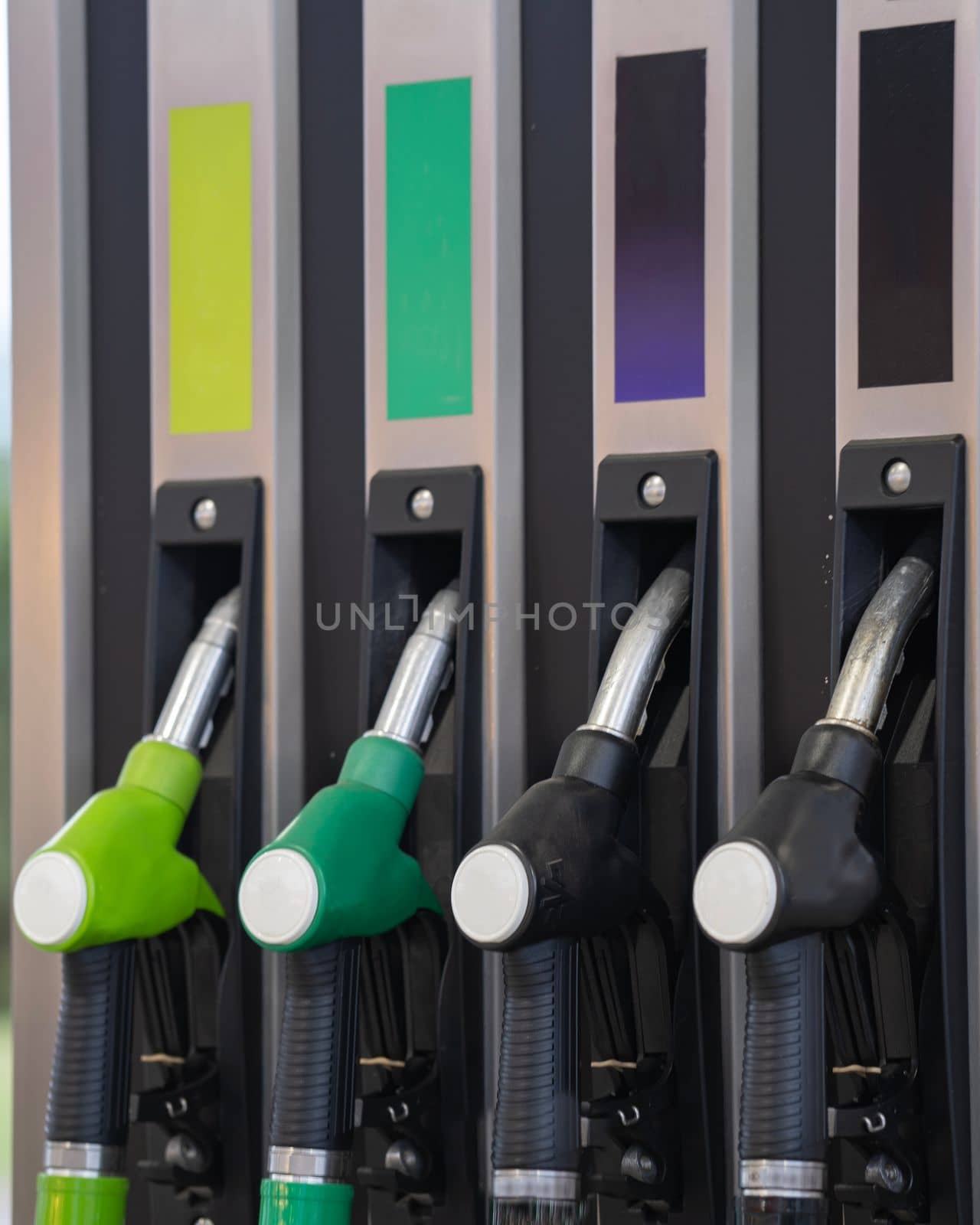 purple green yellow black color fuel gasoline dispenser background. Prices increasing. Transport concept. by papatonic