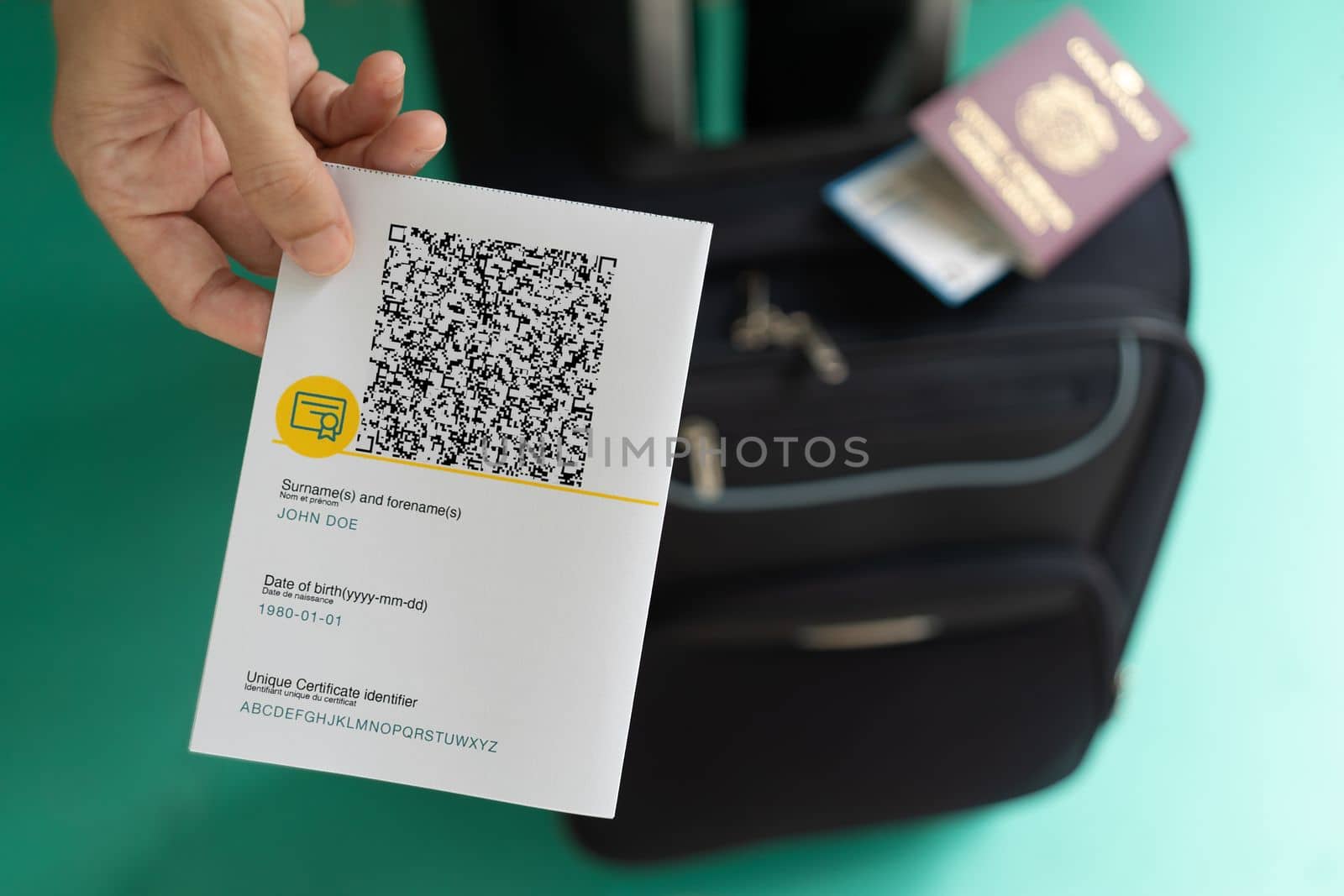 Woman showing EU Covid Certificate with quad code. With baggage.