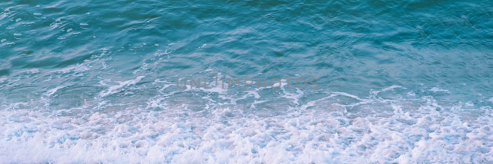 Abstract nature background Sea rippled water surface texture edge wallpaper White foam blue green turquoise.