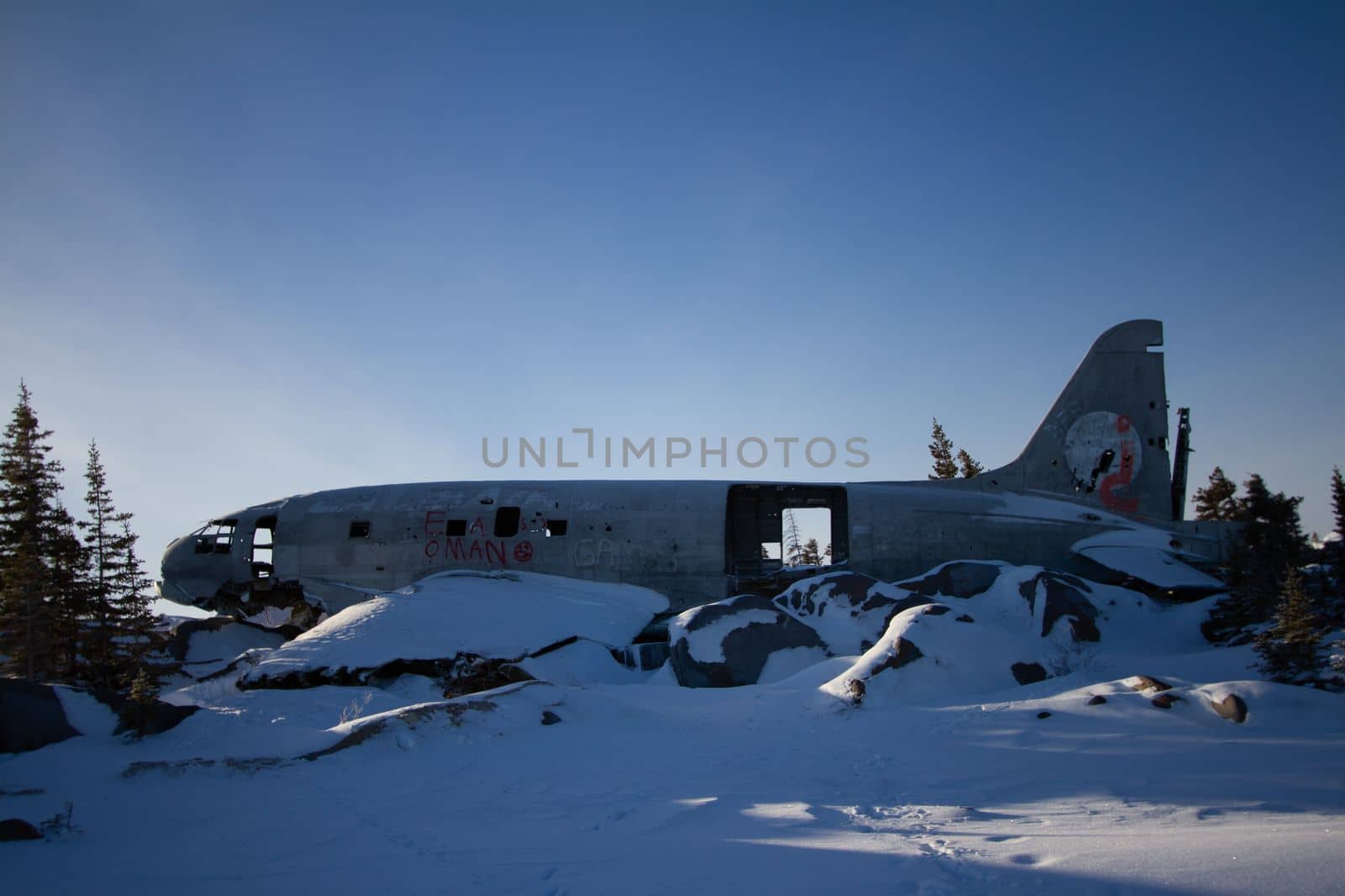 Miss Piggy Plane wreck in Churchill, Manitoba with snow on rocks in front of crash landing site by Granchinho