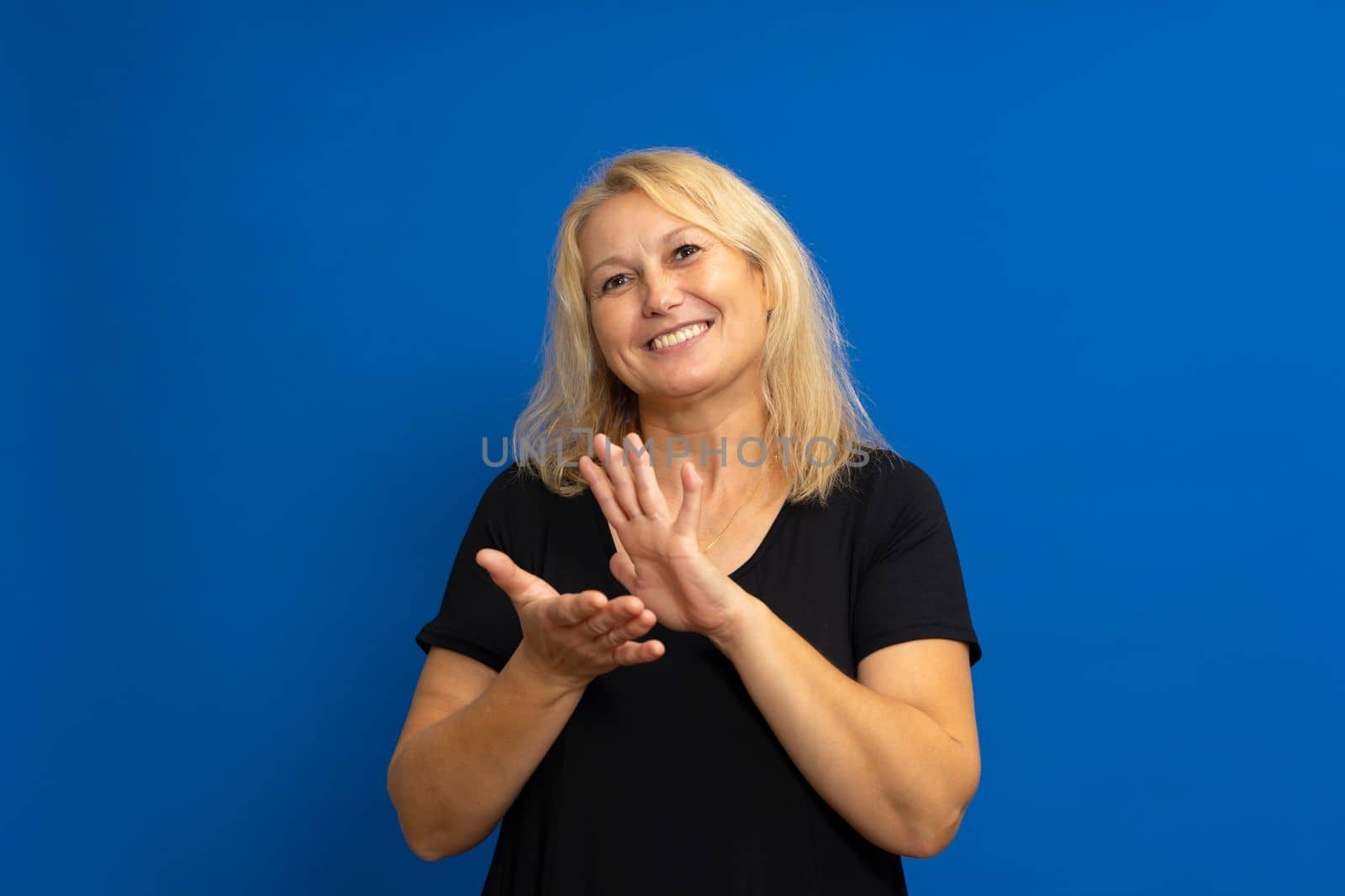 Caucasian blonde woman applauding after presentation at a conference on isolated background