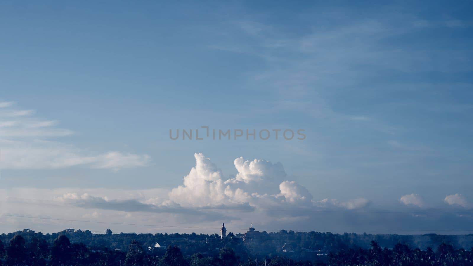 Atmosphere panorama cumulus white clouds over buddhist temple statue. Dramatic Sky Sunset Meditation background.