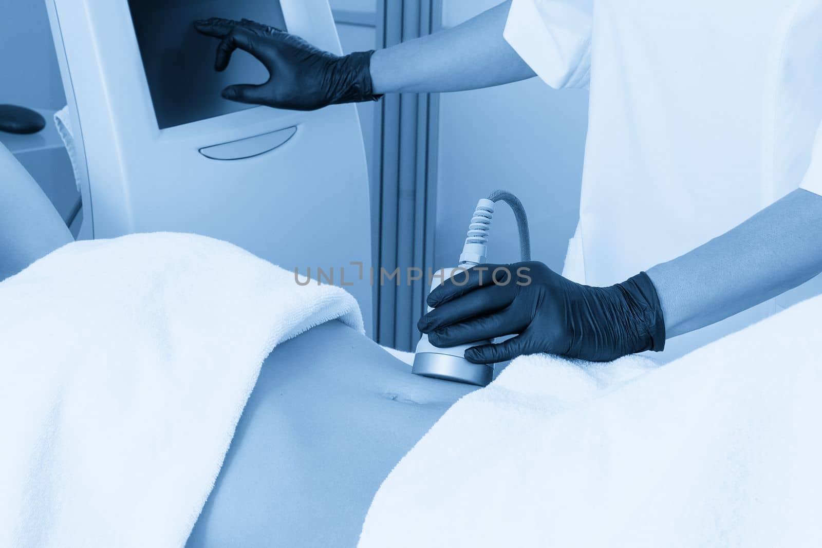 Ultrasound cavitation body contouring treatment. Woman getting anti-cellulite and anti-fat therapy on her leg in beauty salon by Mariakray