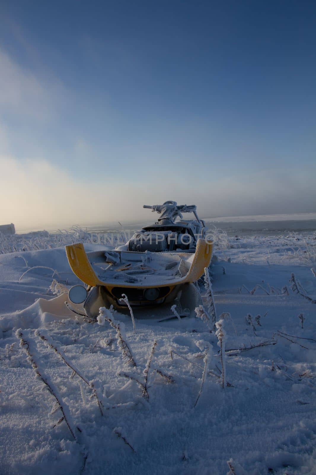Old snowmobile sitting on a snow covered landscape by Granchinho