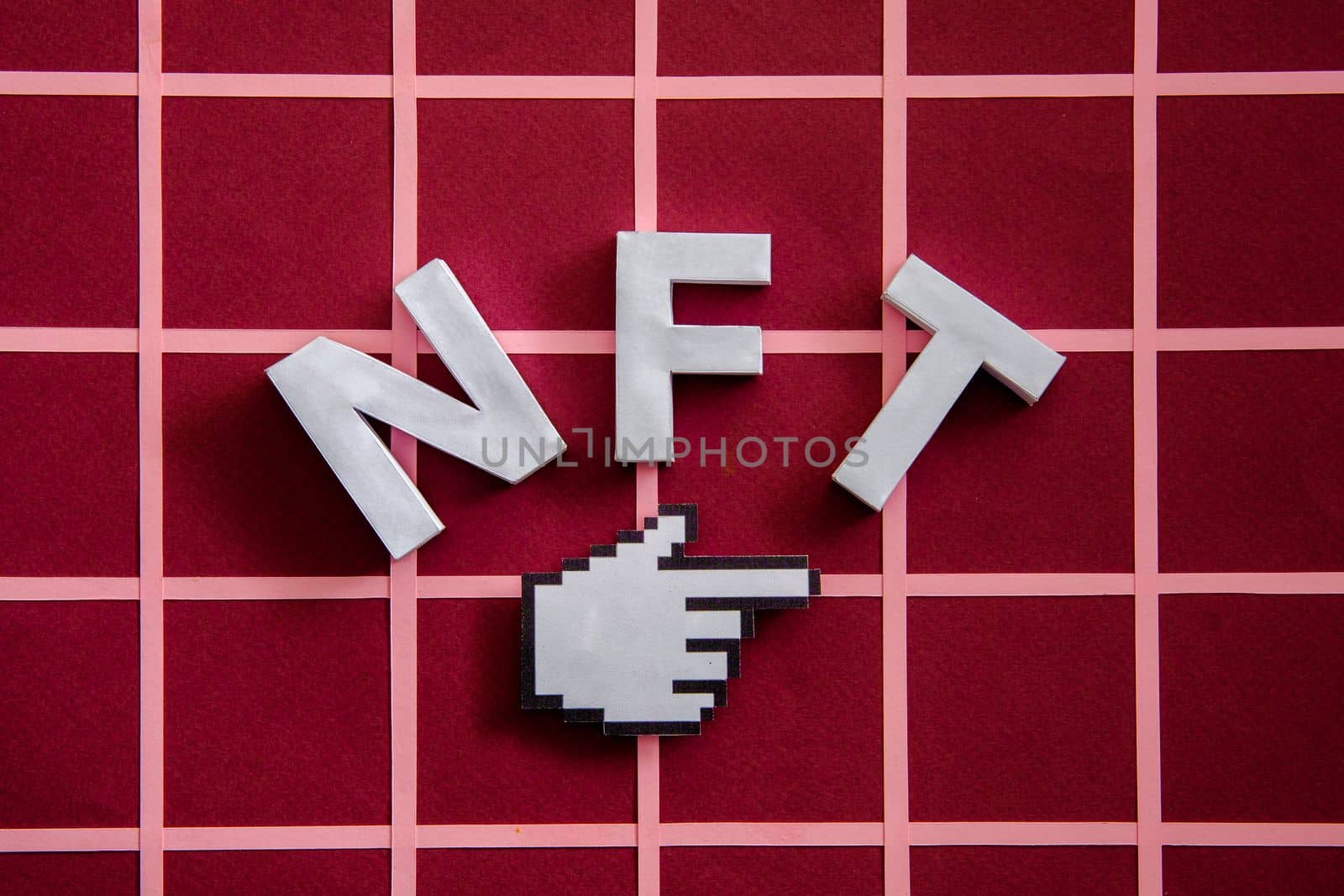 NFT and pixel finger mouse pointer on a red background as a concept of modern online technologies on the blockchain. High quality photo