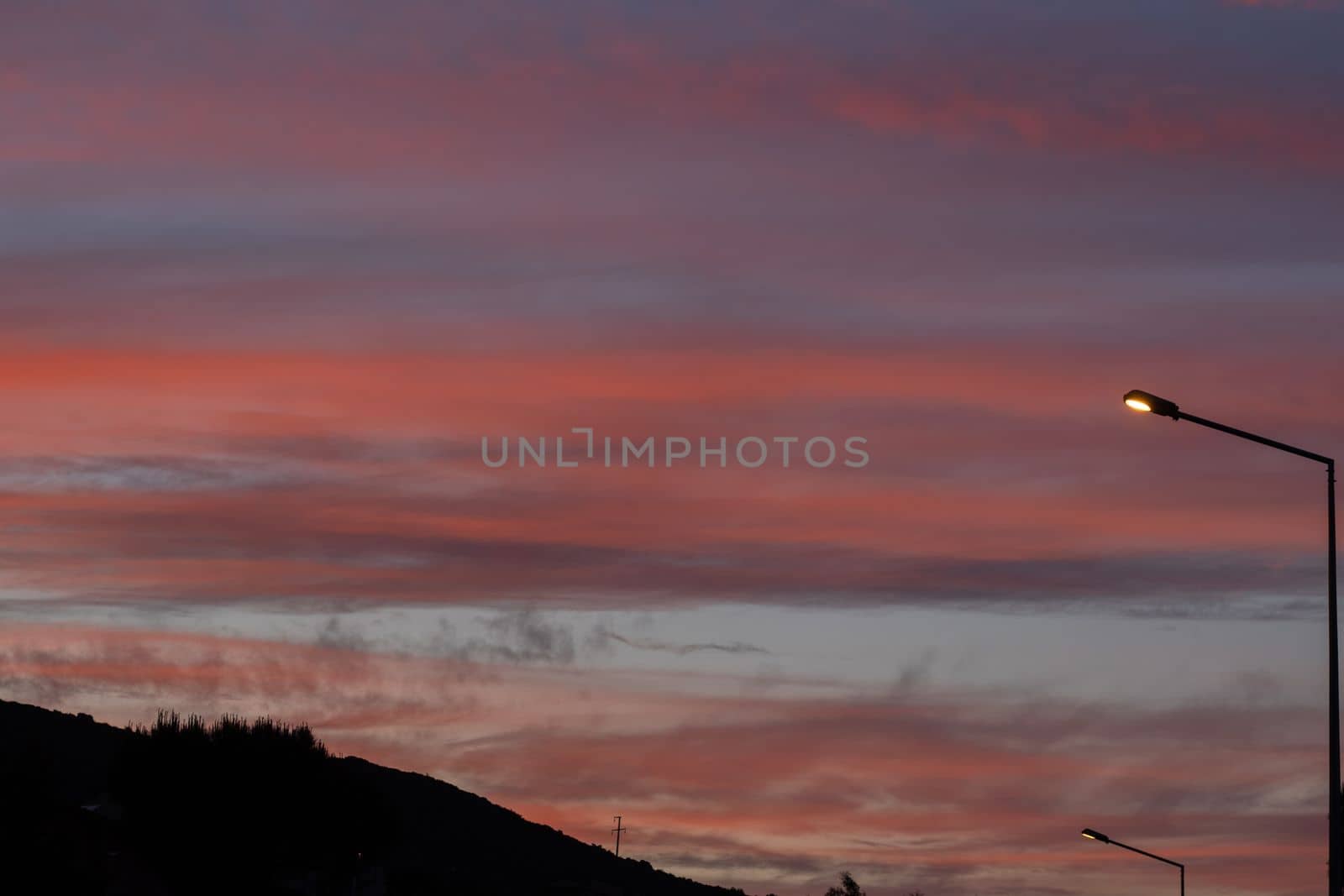 Dramatic sunset landscape at Urla, Izmir, Turkey. Beautiful blazing sunset landscape cloudy sky