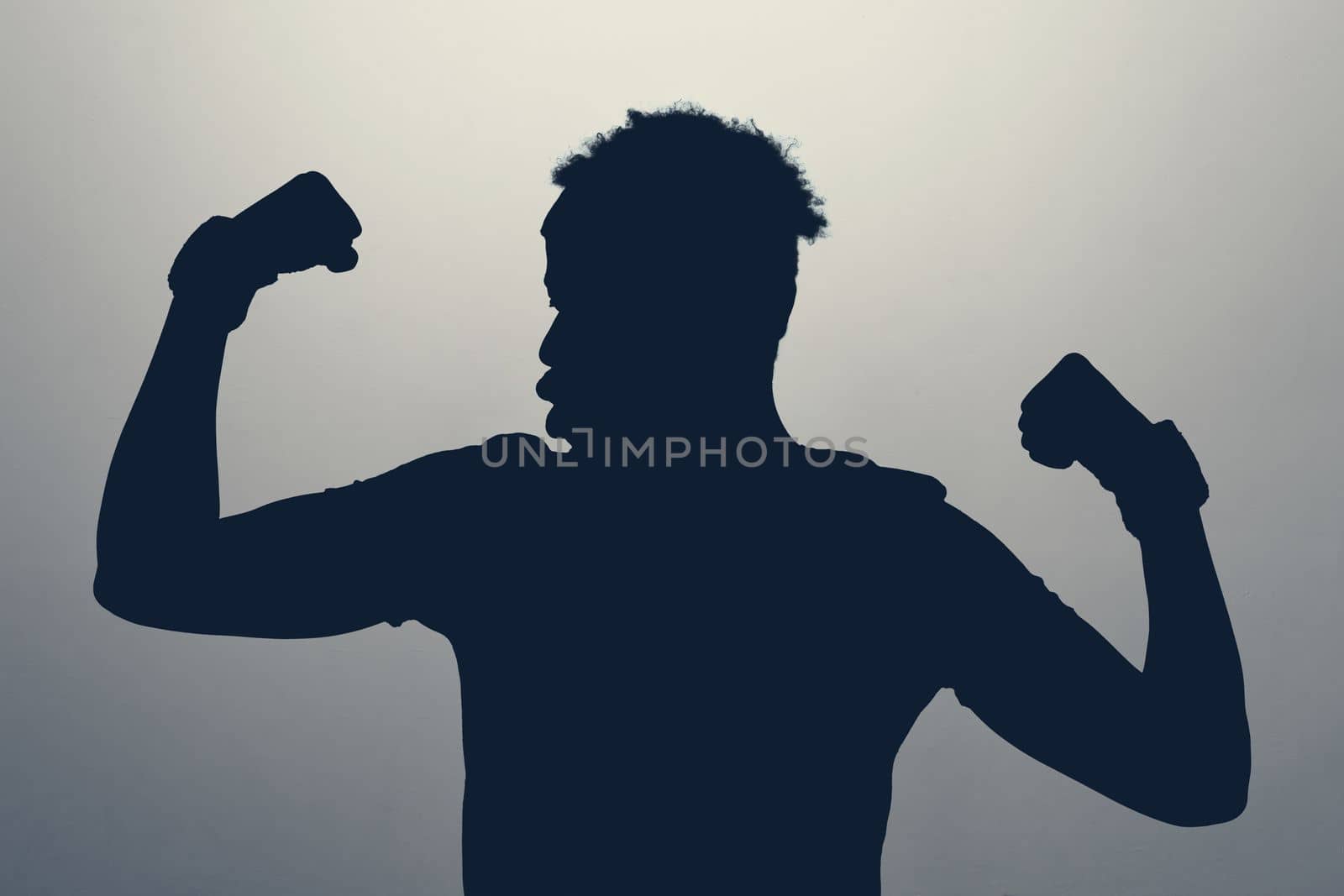 Unknown male person silhouette being proud of his muscle in studio. Concept of healthy lifestyle