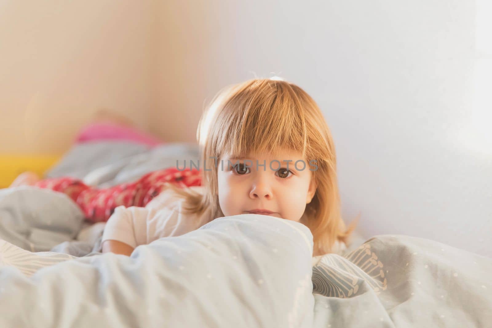 charming beautiful baby lying on the bed.