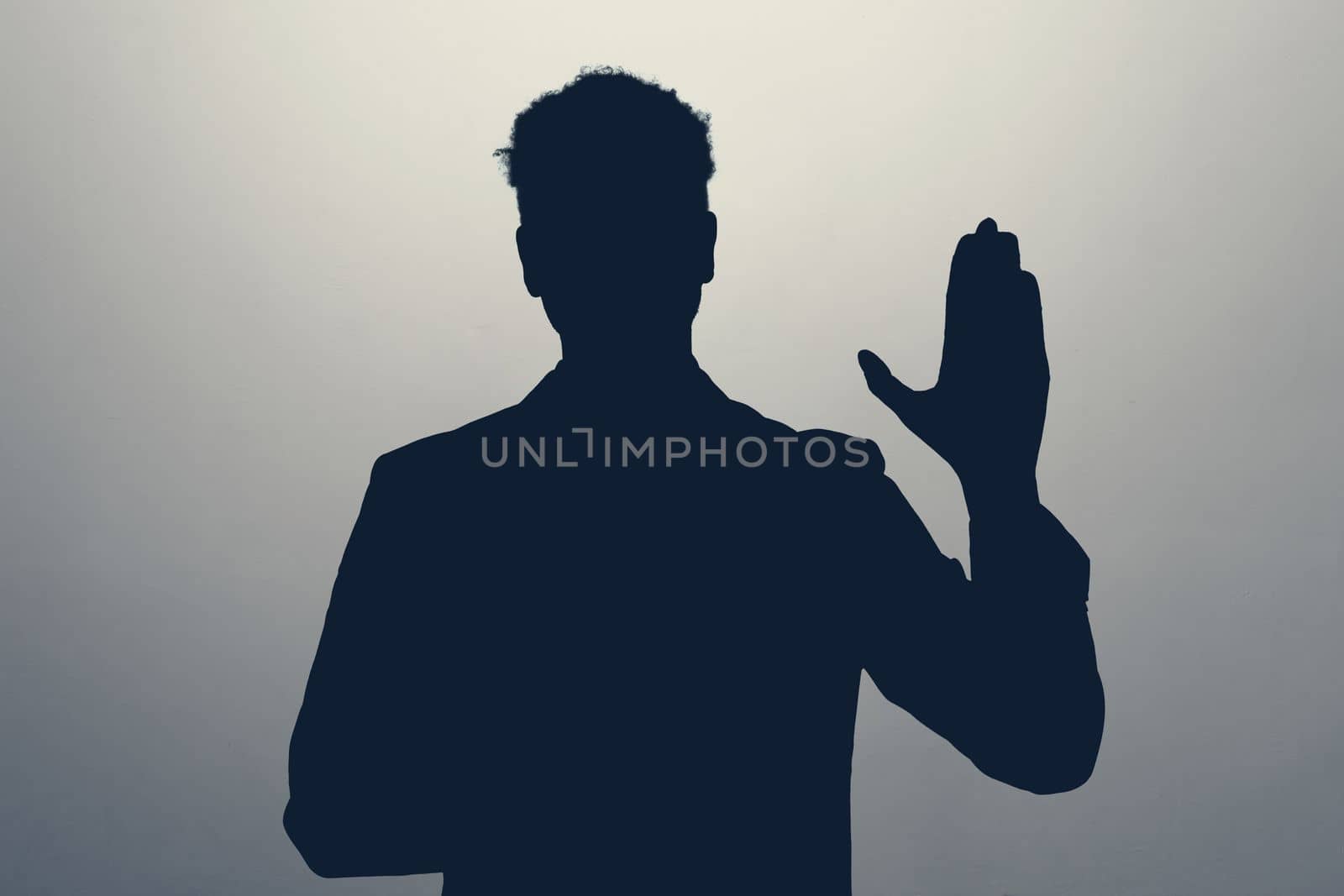 Unknown male silhouette making a promise or oath