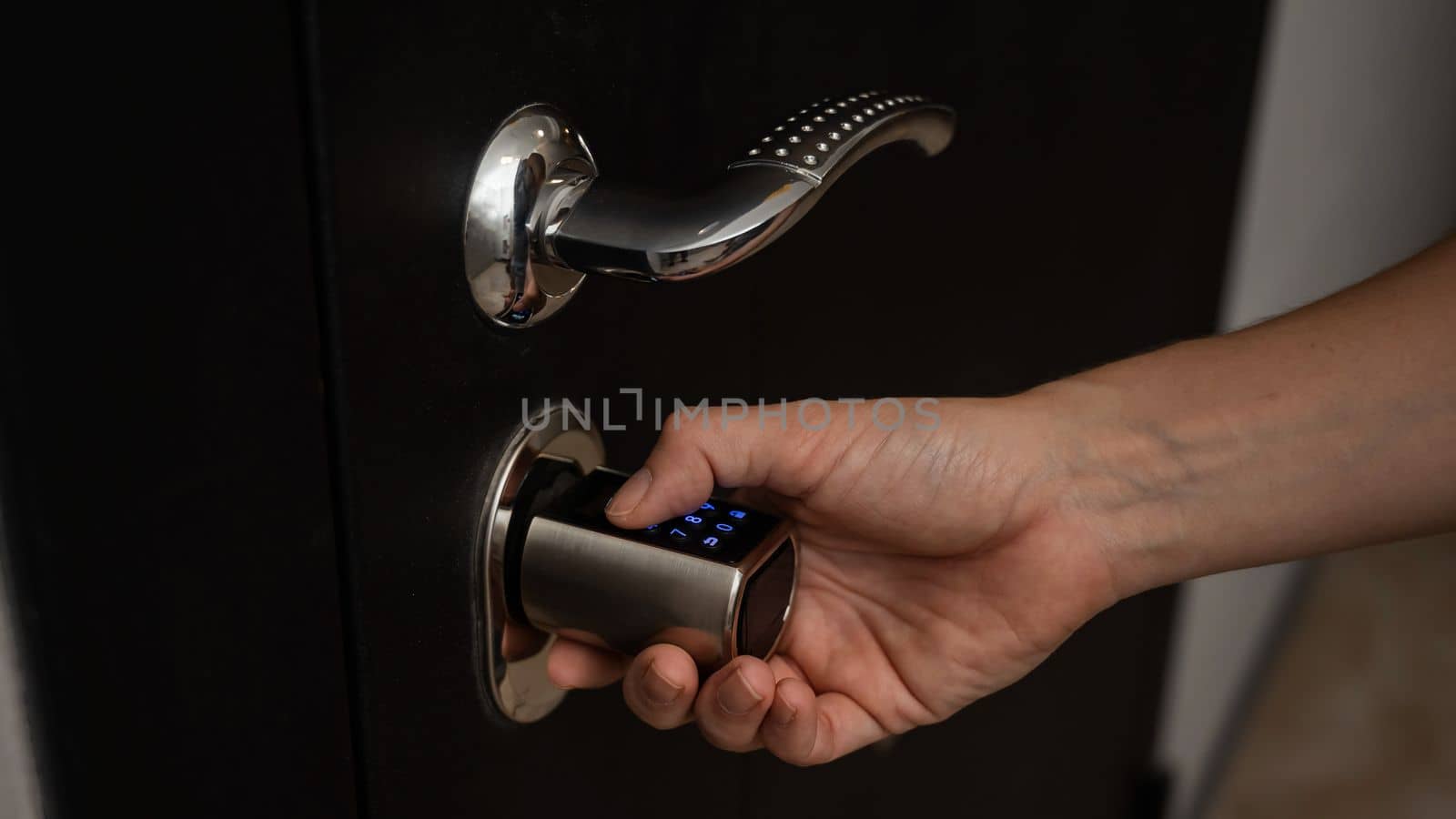 Woman opens the combination lock on the door to the apartment. Keyless entry