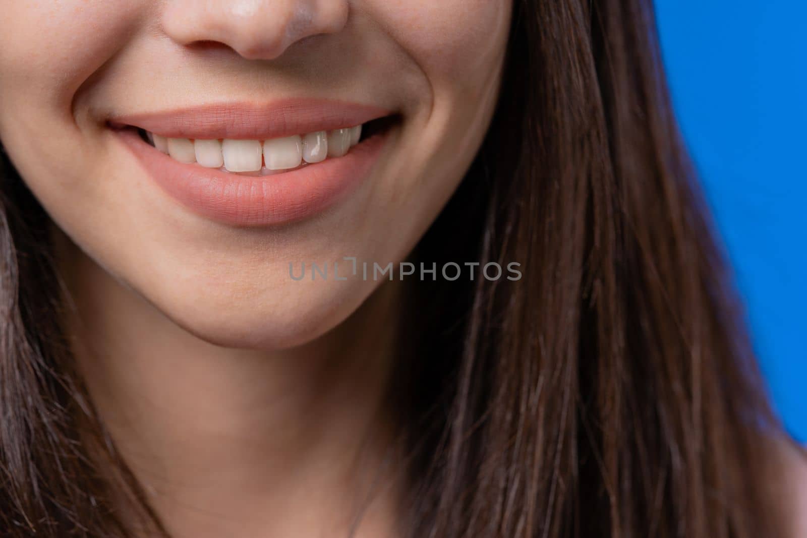 Close-up smiling mouth of woman. Perfect white healthy teeth. Emotional fun and joy lifestyle. Dental care, lips background, stomatology concept. High quality photo