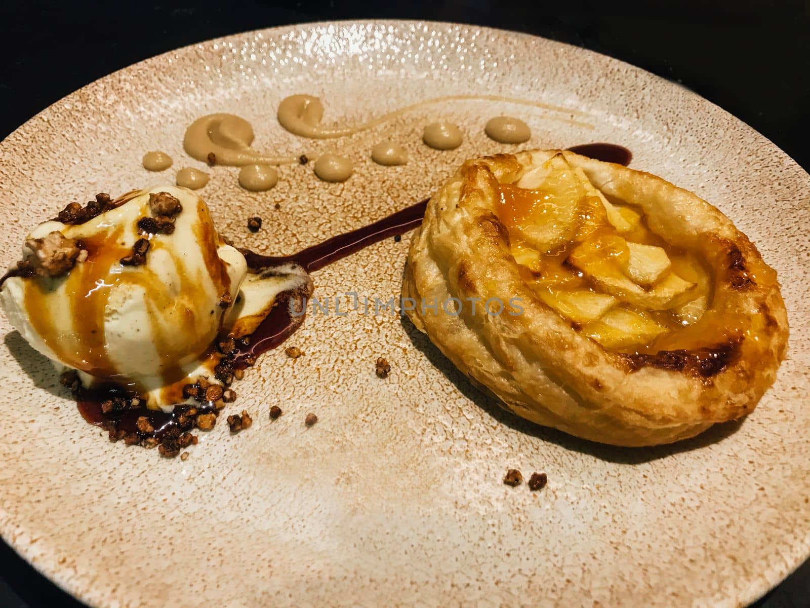 Small Apple pie with caramelised ice ball served in restaurant.