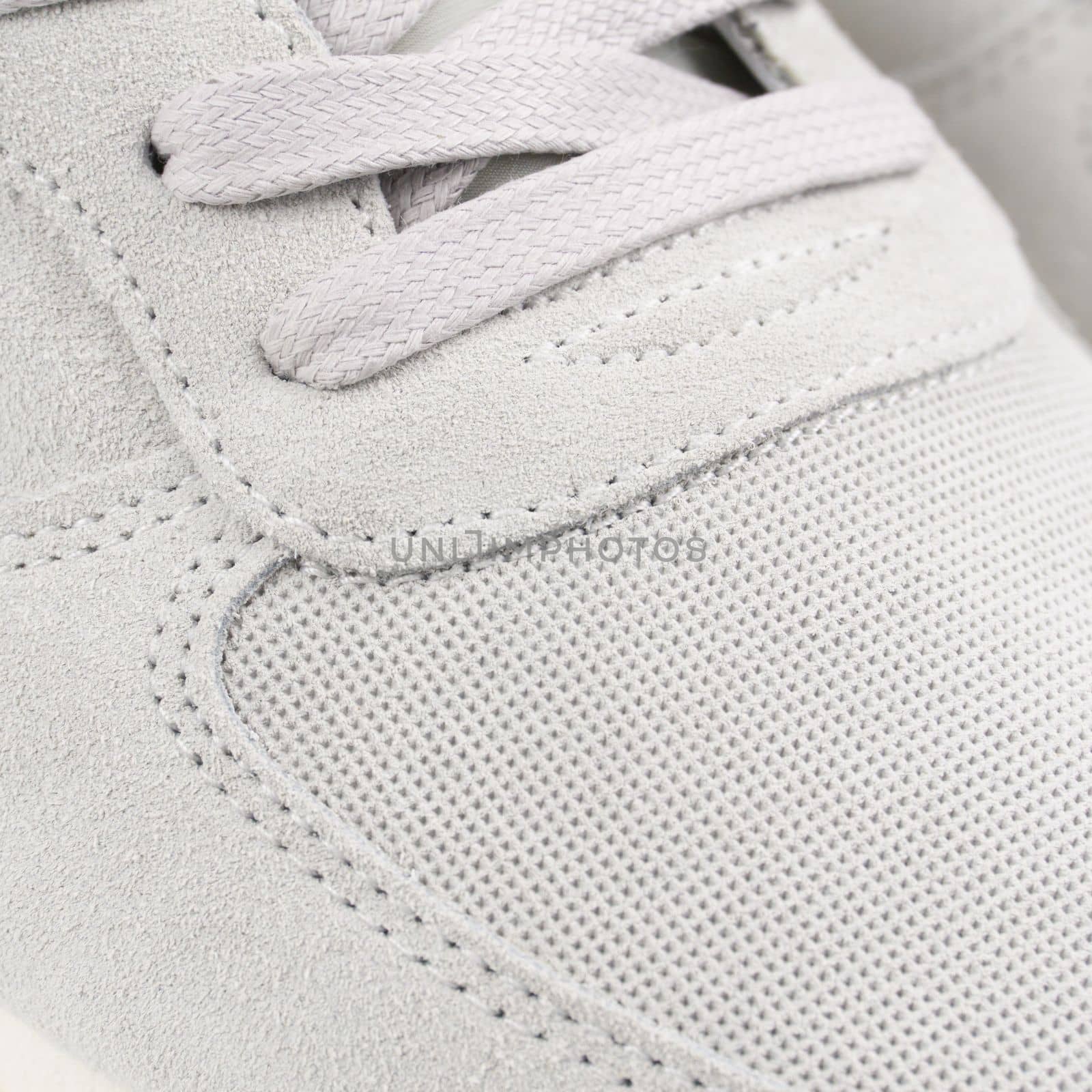 Lacing on the light grey sneaker close up