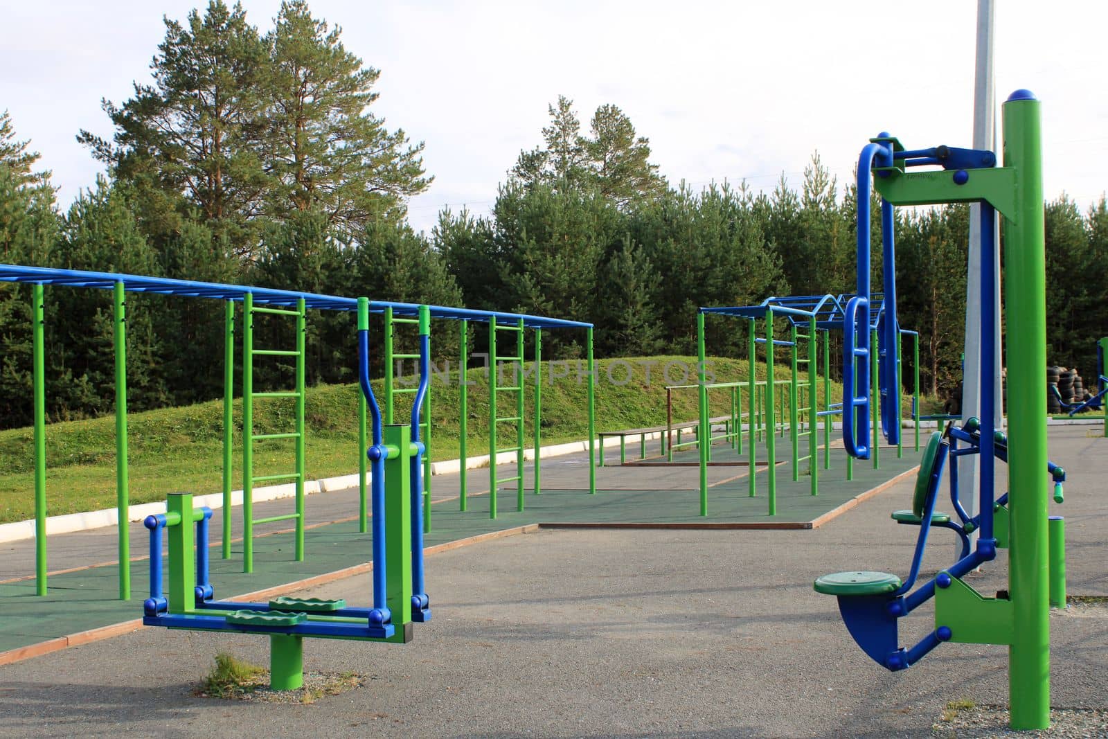 Sports street playground with exercise equipment on the background of the forest. The concept of a healthy lifestyle