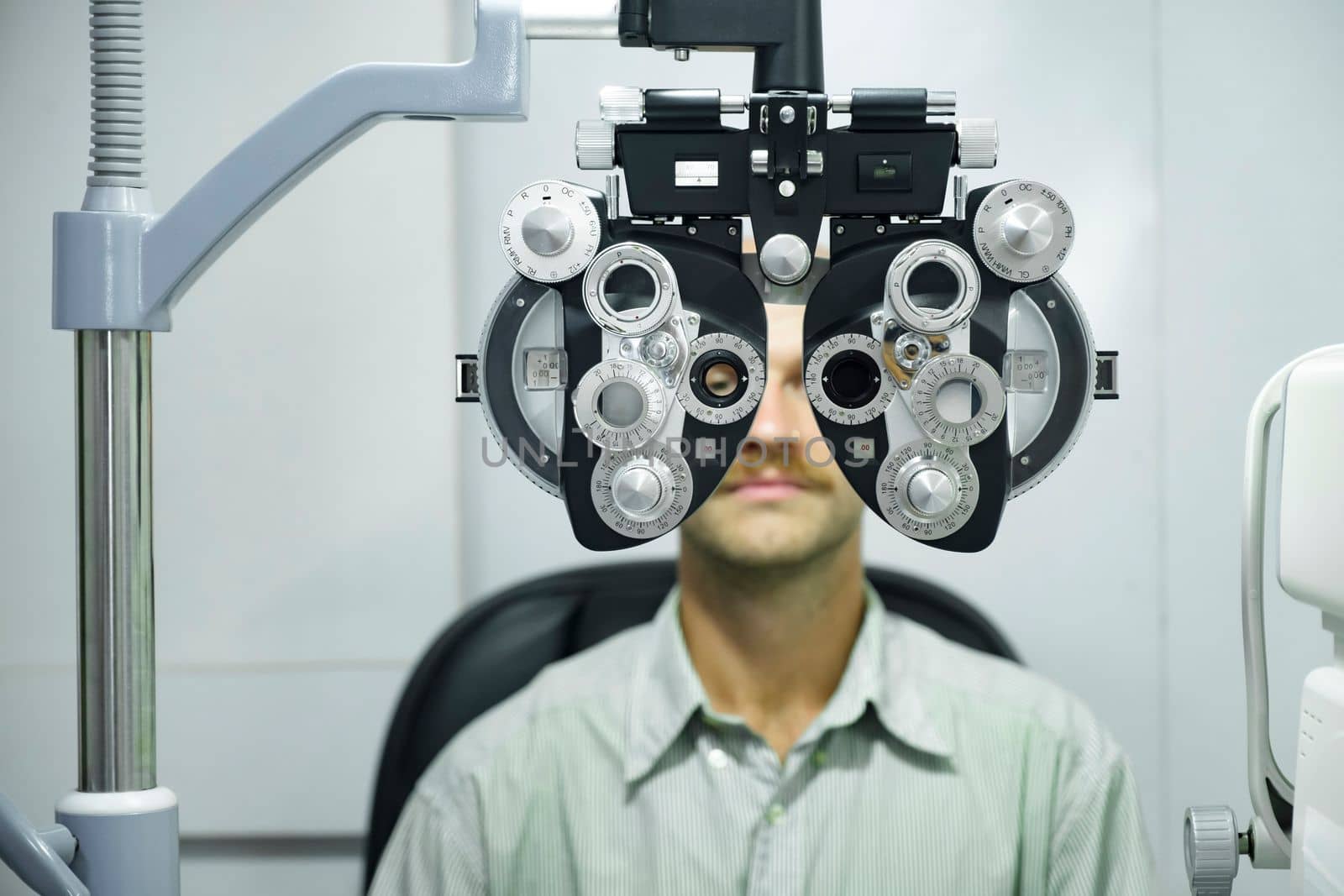 Man having eye test using phoropter. by ijeab