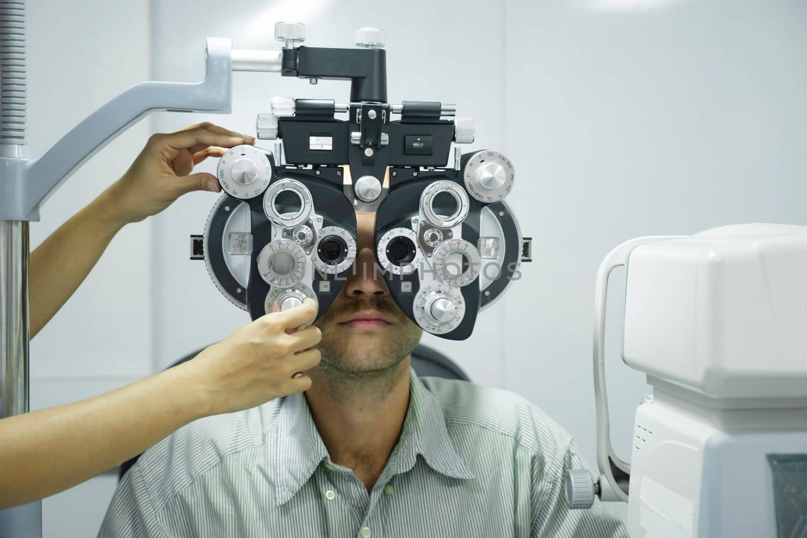 Man having eye test using phoropter. by ijeab