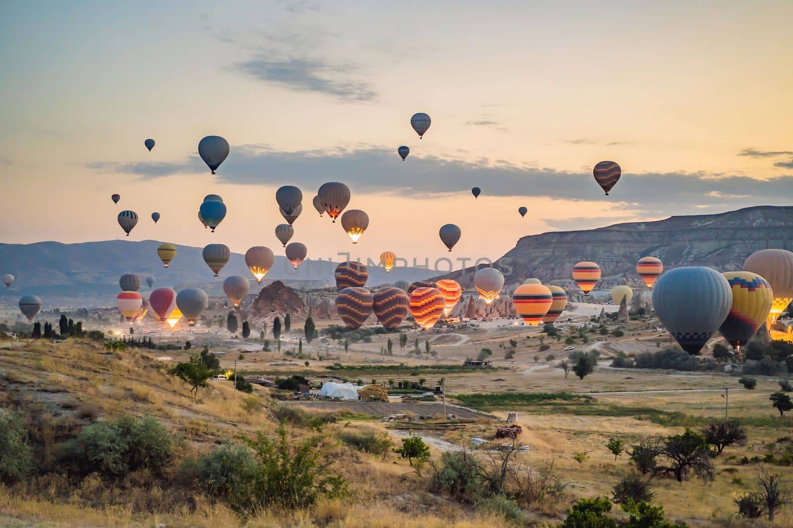 Colorful hot air balloon flying over Cappadocia, Turkey by galitskaya