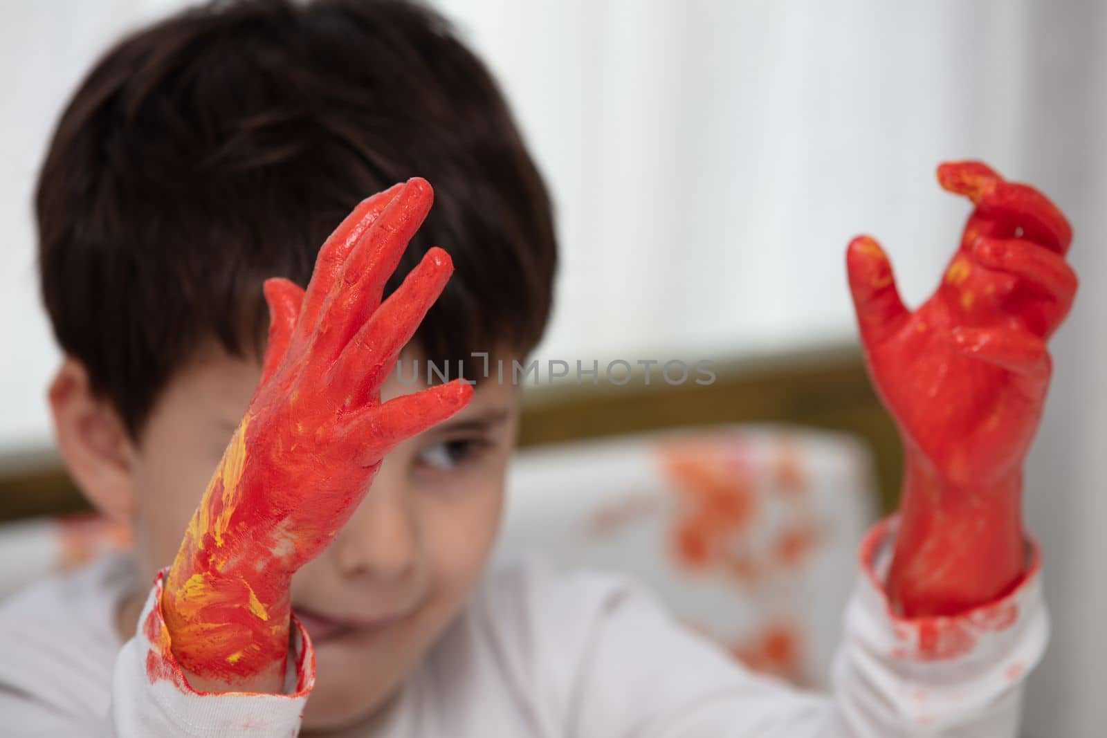 Close up young boy painting with colorful hands. Art, creativity and painting concept by senkaya