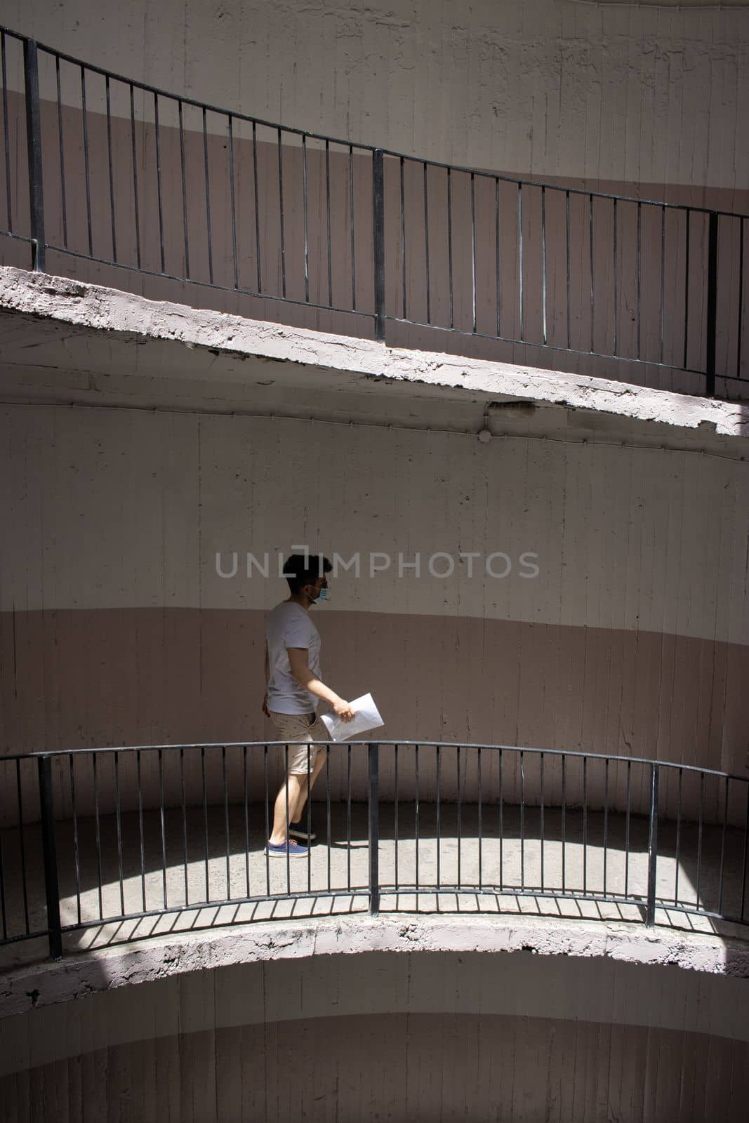 old and dirty car parking area with spiral stairs